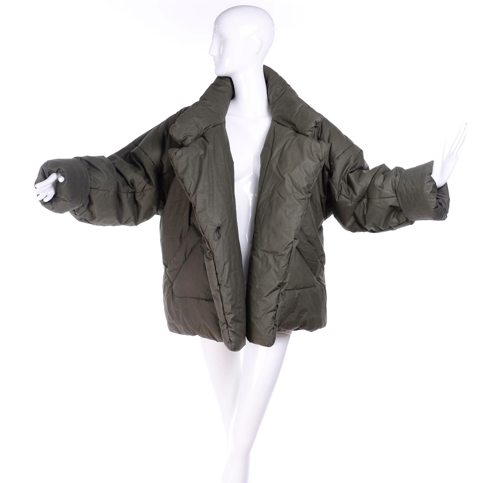 This is an iconic vintage Norma Kamali puffer coat in a great shade of army green. This vintage 1980's coat has the older OMO label. Norma Kamali originally designed these coats when she went camping and found that she would wrap herself in her