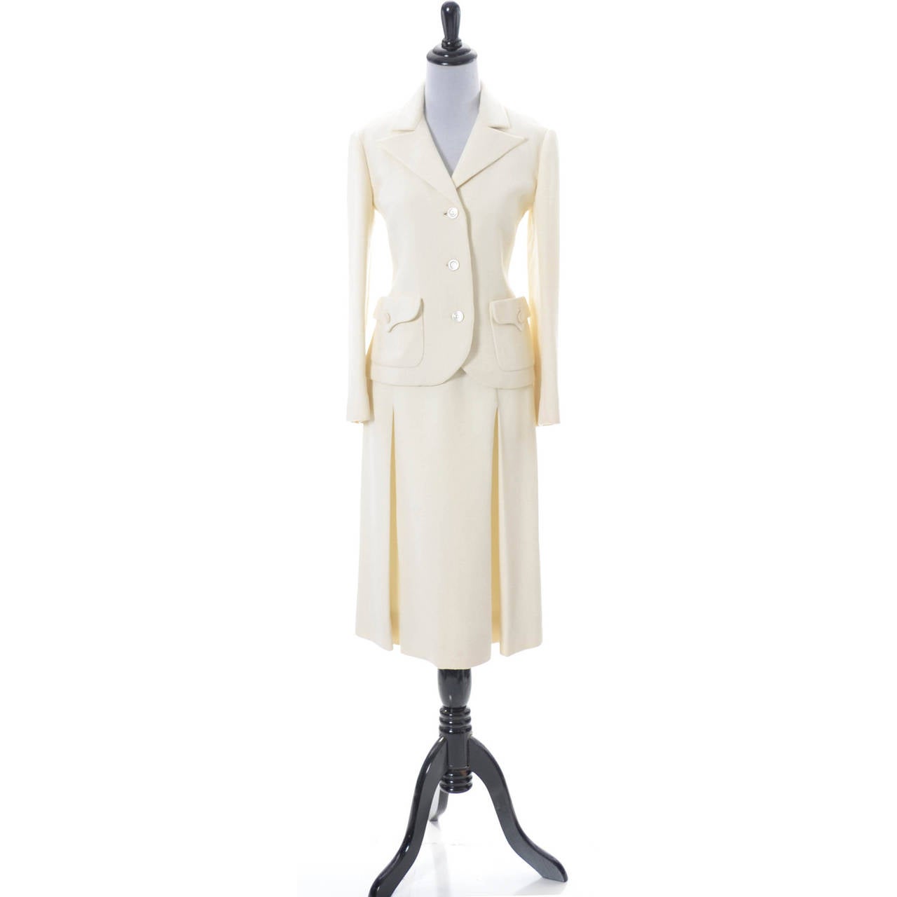 This vintage skirt suit is from Valentino and bears the early Boutique Valentino New York/Rome Made in Italy Brown and White label. I believe this suit is from 1969 or 1970.  The suit is made in a winter white medium to heavier weight wool crepe and