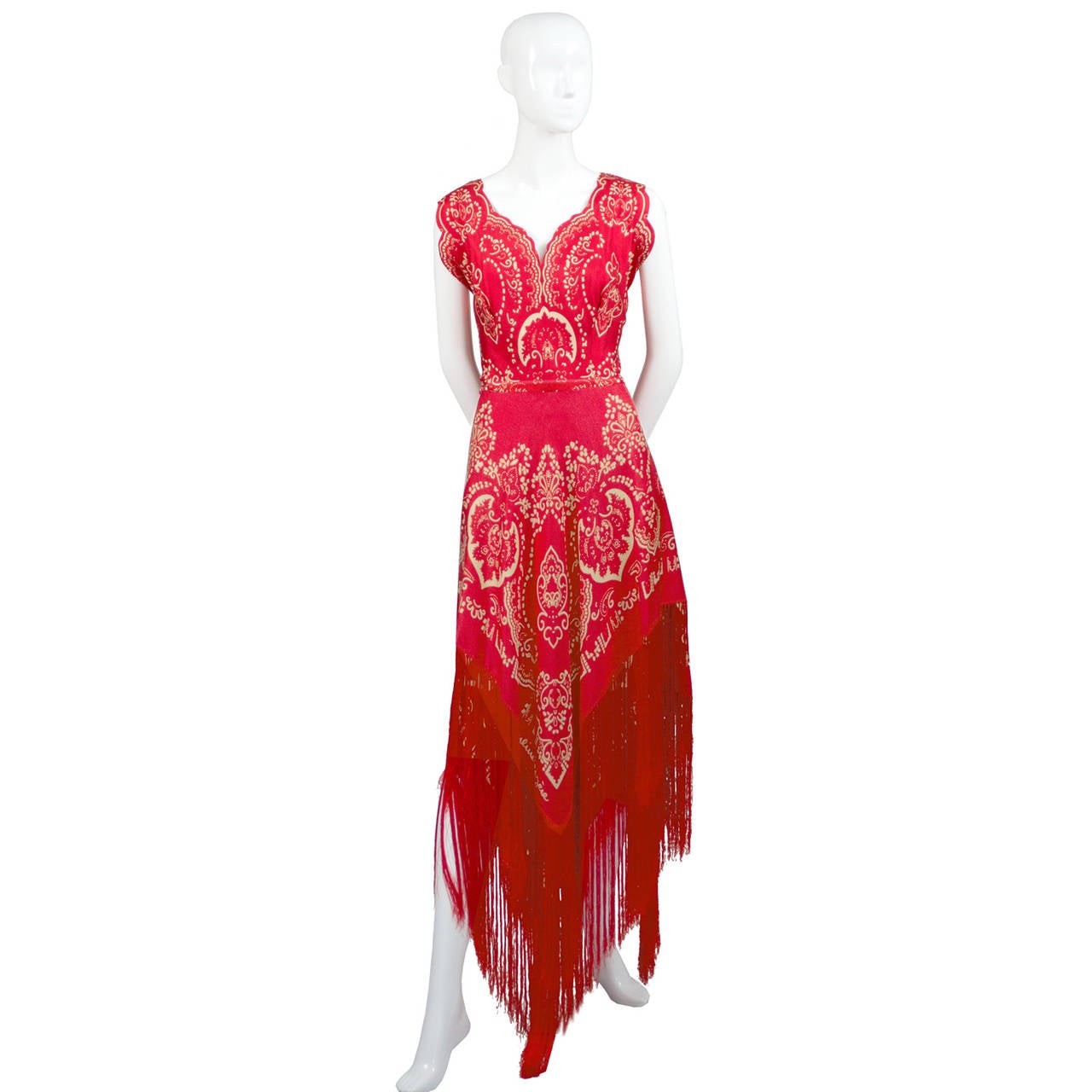 This is a fabulous 1970's silk vintage dress from Pauline Trigere. This rareincredible red dress has a beautiful white design that includes Pauline Trigere's signature in the pattern of the fabric itself! The beautiful red fringe is 12 inches long