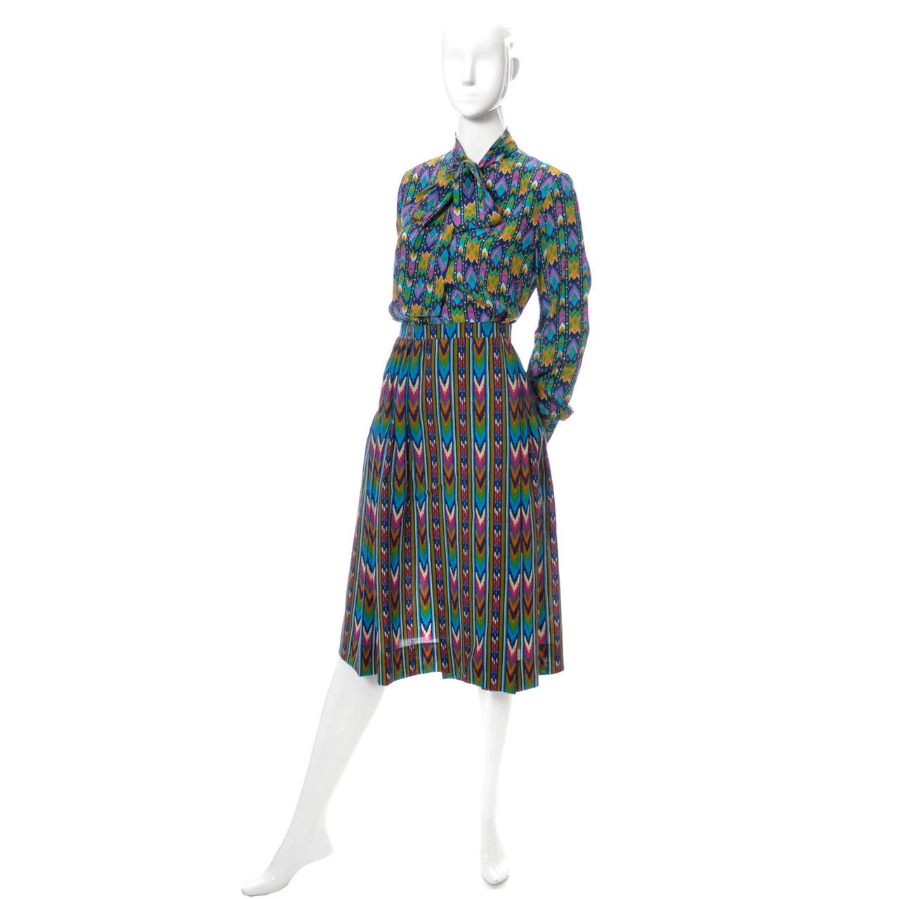Beautiful vintage 1970's 2 piece dress from Yves Saint Laurent Rive Gauche Paris! The lovely silk blouse has a sash and the wrap pleated skirt is in a coordinating fabric. The blouse sash can be tied with a bow as shown or tied loosely at the neck