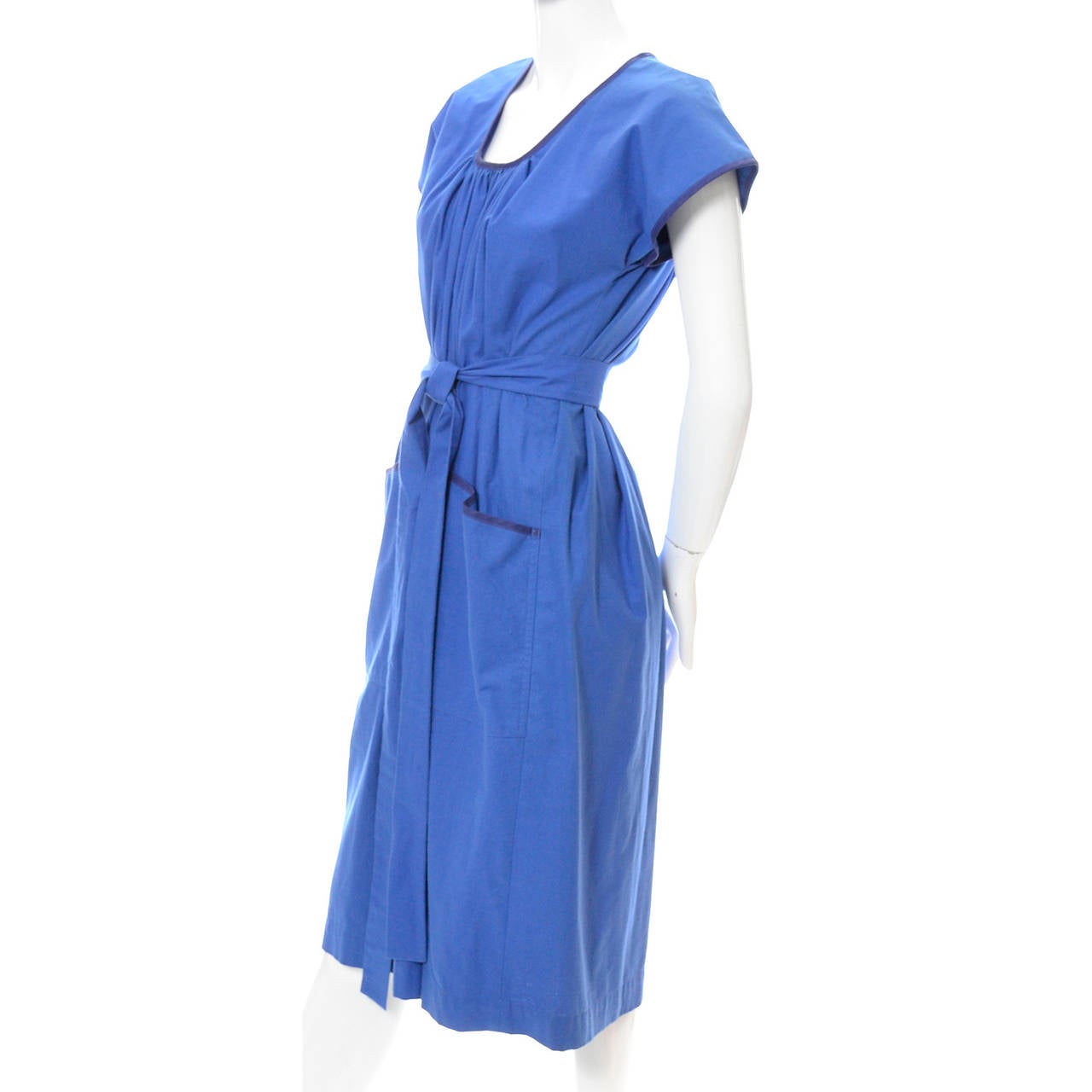 This 1970's vintage dress is from Yves Saint Laurent and has the Rive Gauche label. This YSL vintage dress has front pockets and the original fabric sash. This is a loose fitting, peasant style dress that cinches at the waist. This dress is in