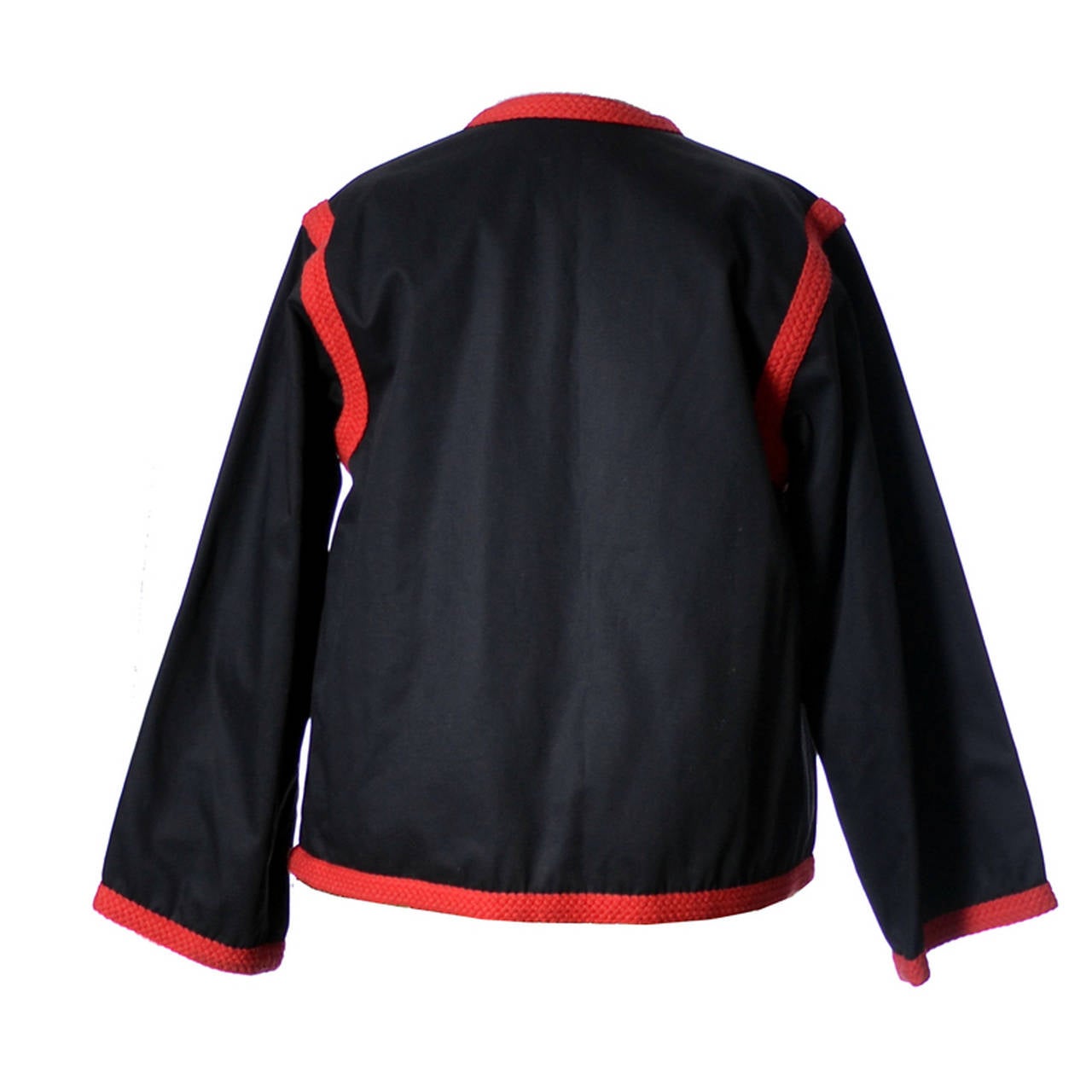 The 1970's vintage Yves Saint Laurent Rive Gauche Jacket is in black Cotton with red knit trim.   This pristine jacket  has a 38 inch bust and is 24 inches long from the nape of the neck. This wonderful vintage YSL jacket came from an estate that
