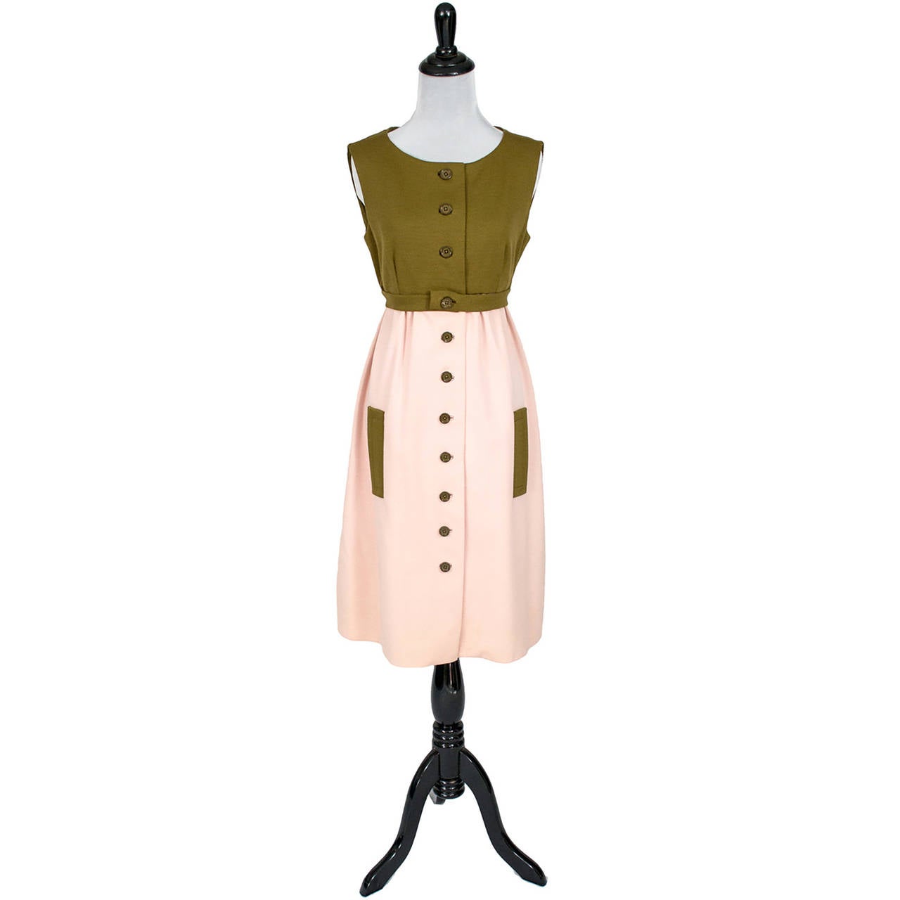 This is a classic 1960s Collectible vintage dress from designer Jacques Tiffeau in a pink and olive green / brown 100% wool knit.  This sleeveless dress has an empire waist and buttons up the front. The dress is in excellent condition and comes with