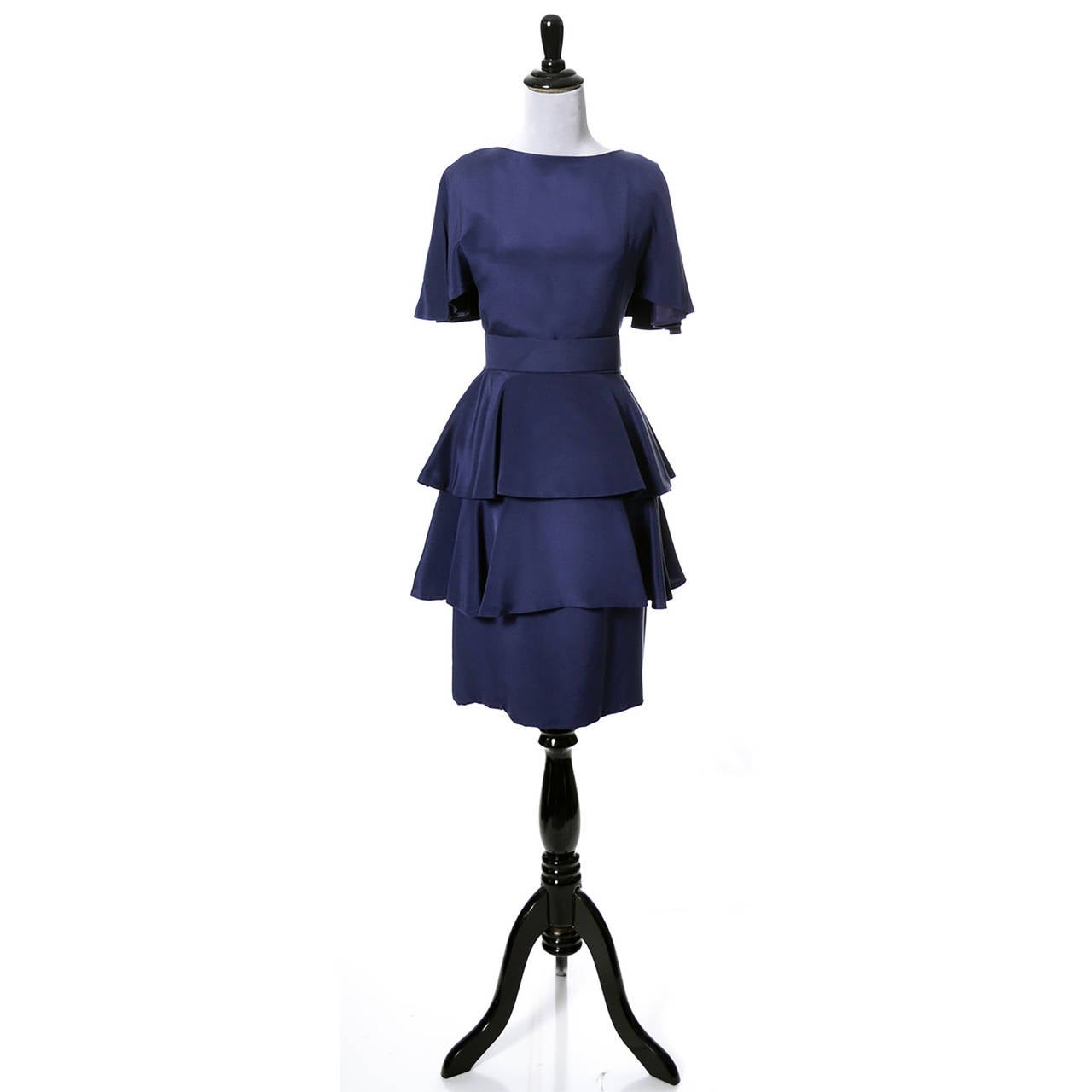 This pretty blue vintage dress was purchased at Neiman Marcus in the early 1980s. The dress has its original fabric belt, a back zipper and a slim skirt under 2 layers of gentle ruffles. The dress is actually sleeveless with an attached 
