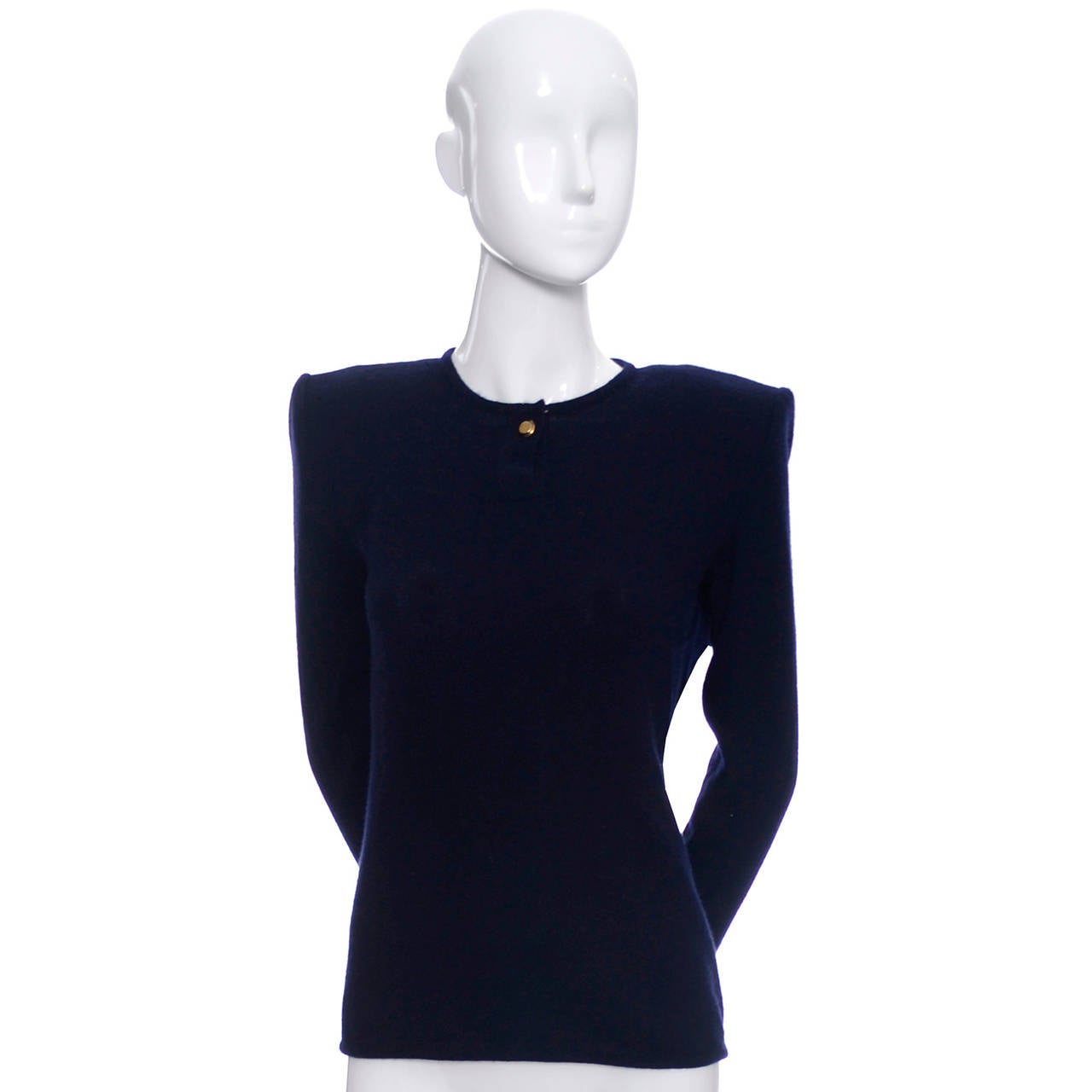 This is a beautiful Valentino Boutique vintage cashmere navy blue sweater with shoulder pads and a single brass button. The sweater is in as new condition and is a wonderful, classic piece to own for years to come.  Made in Italy in the early 1980's