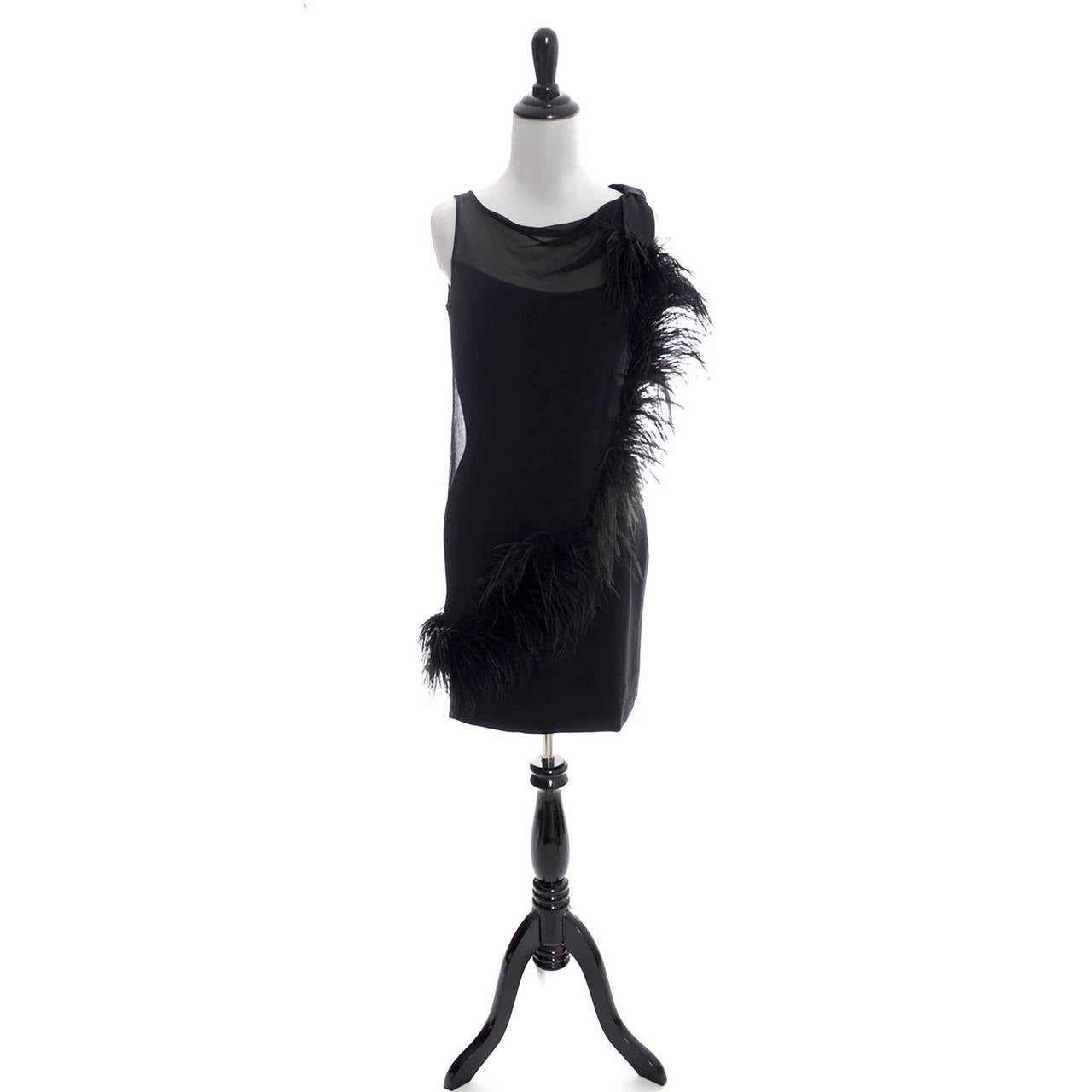This vintage late 1960's or early 1970's little black dress with illusion bodice is from Lilli Diamond and it is in excellent condition. The silk crepe sleeveless under dress has a pretty sheer overlay that is trimmed with amazing black feathers.
