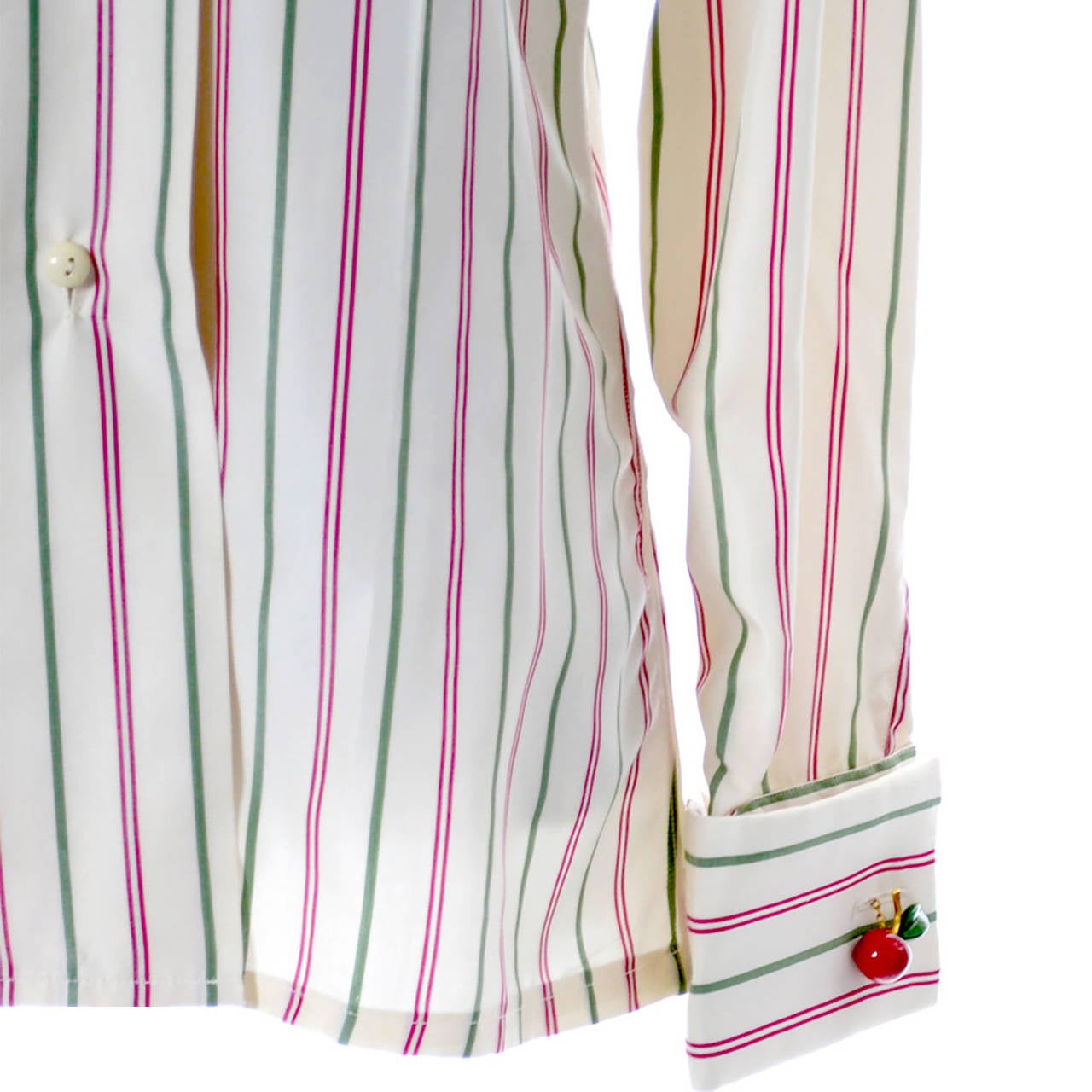 This fabulous striped silk Valentino blouse was made in Italy in the early 1970's. It has buttons up the front and nice french cuffs. Leave it to Mr. Valentino to design the perfect metal red cherry cufflinks with the V logo to go with it! This is