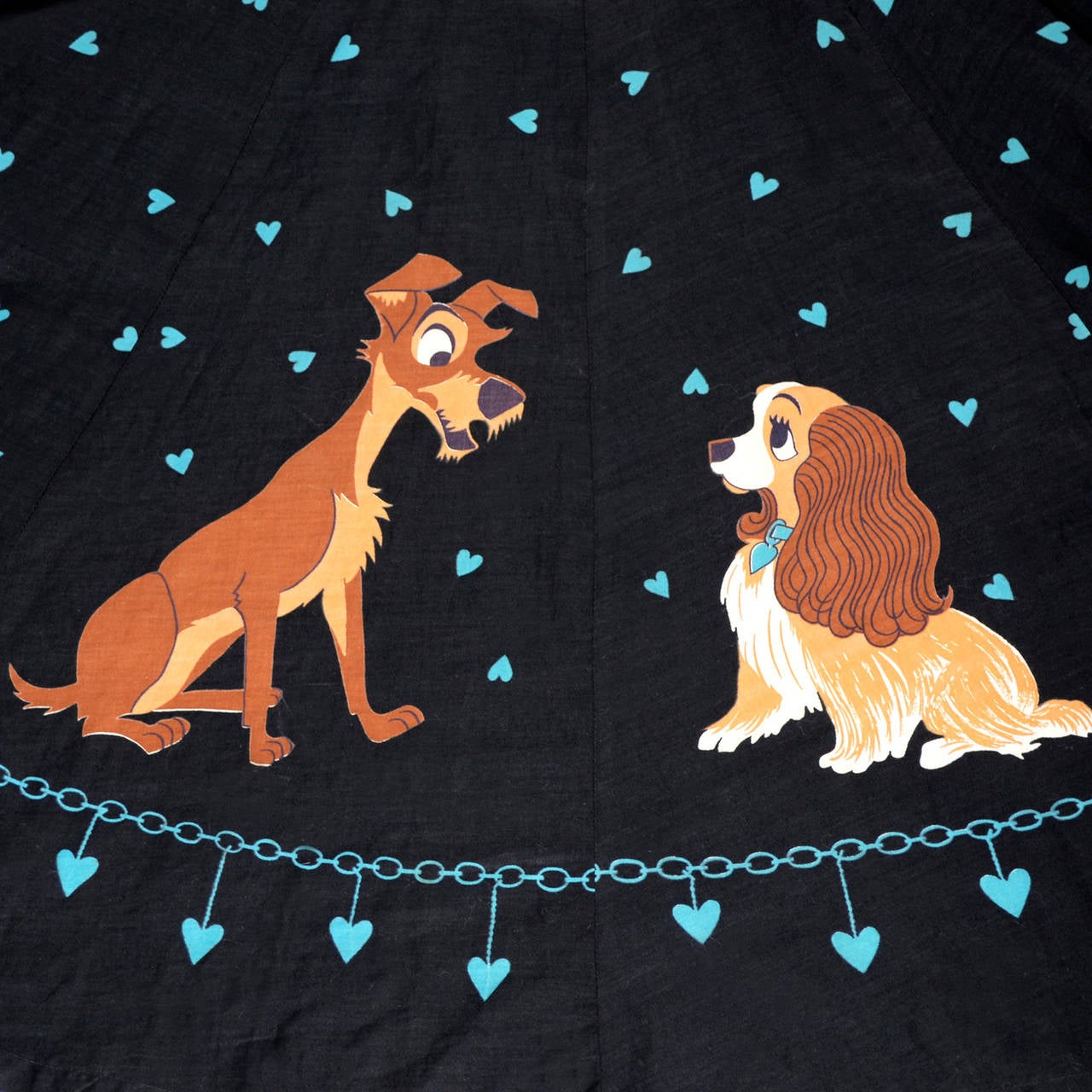 This is a rare vintage cotton skirt from the 1950s made of 16 panels depicting Lady and the Tramp! This adorable novelty print skirt has a metal zipper and a single button closure and measures 30 inches in length. This is an XS skirt as the waist