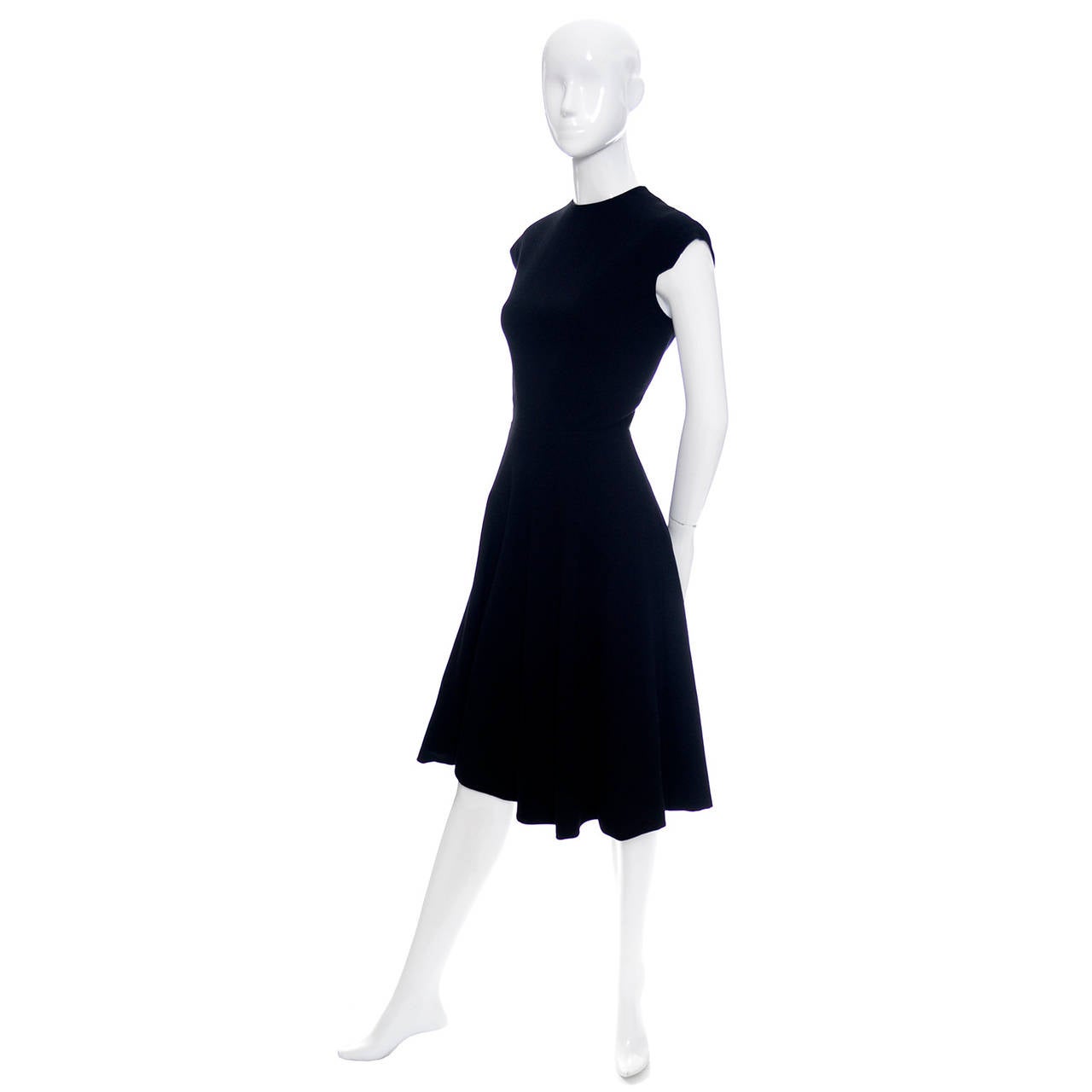 Beautiful early 1970' classic wool crepe black vintage dress from designer Pauline Trigere. This dress has pretty detailed cap sleeves, a fitted waist, and a flounce skirt.  The dress was purchased at Saks Fifth Avenue and it is in mint condition.