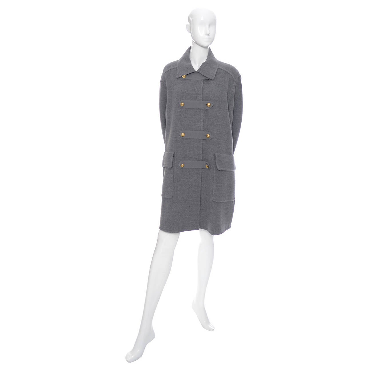 This is a great vintage oversized coat from Salvatore Ferragamo. This piece is similar to a pea coat in style, in a soft gray wool with pretty brass buttons and it was made in Italy in the 1980's.  Oversized fit, it is marked a size small but can