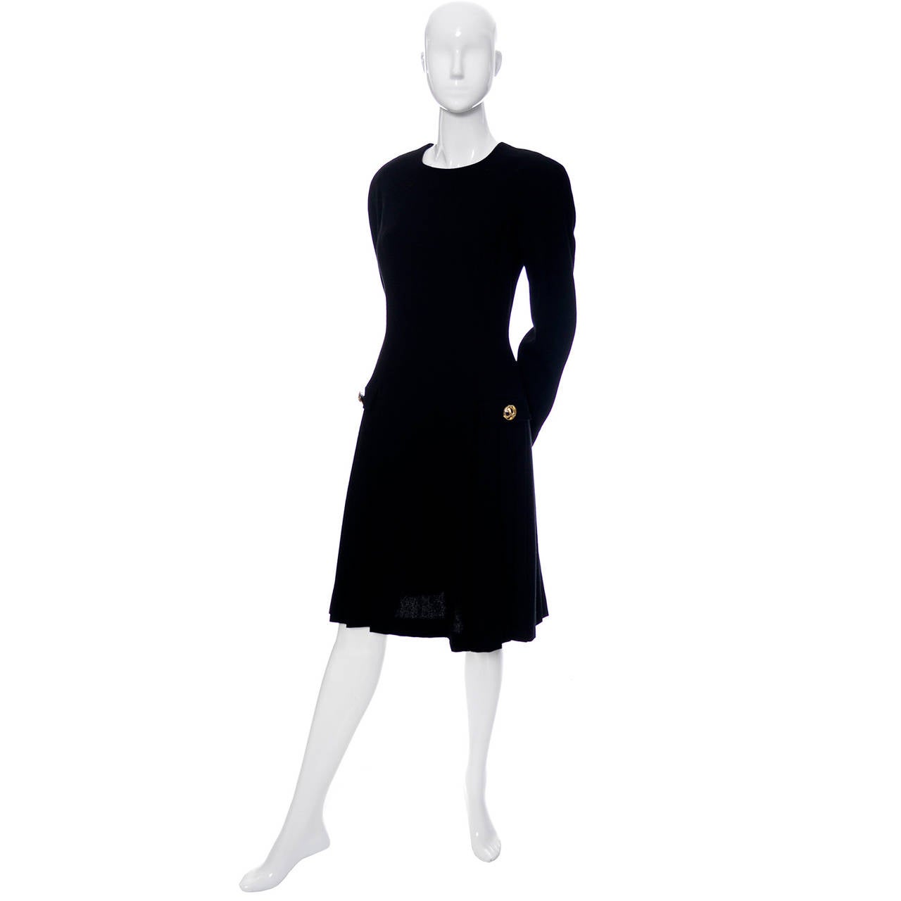 This is a classic vintage black dress from Arnold Scaasi. The drop waist black wool knit dress is fully lined and is from the early 1980's. The dress has a pretty pleated skirt, dolman sleeves, and a back zipper. This dress is in excellent condition