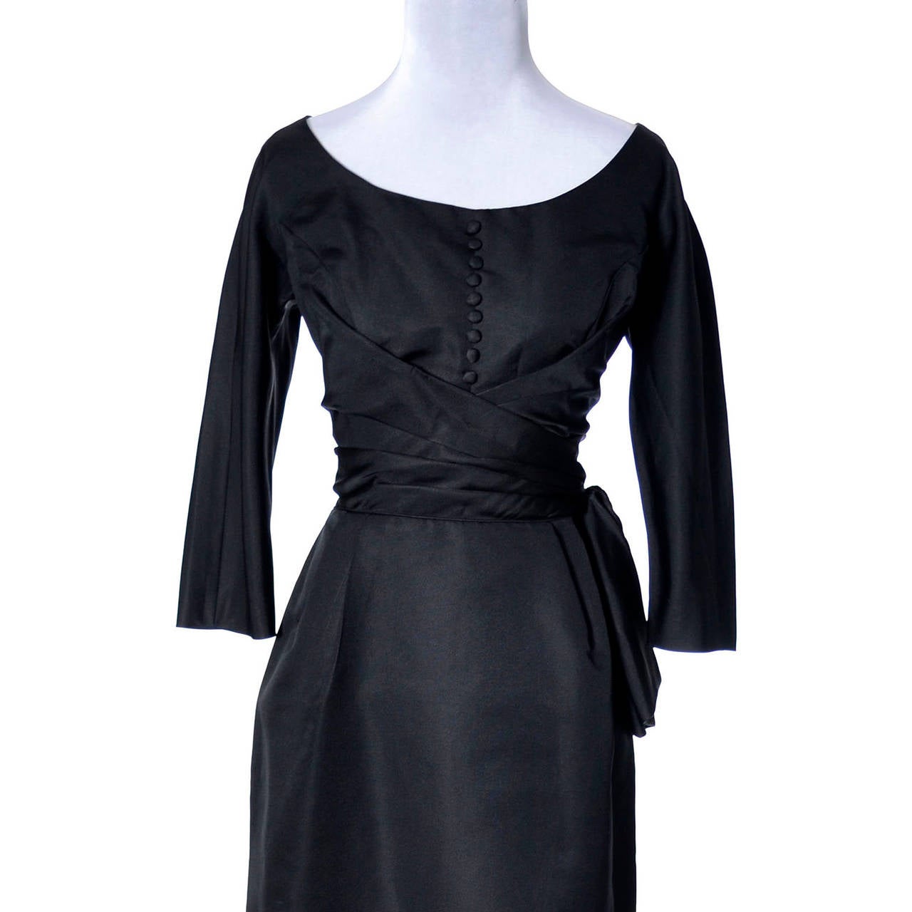 This stunning Vintage dress designed by Max Lawrence was purchased at B. Altman & Co. on Fifth Avenue in New York in the early 1950's. This gorgeous black vintage dress is very flattering with back zipper, side bow and tiny covered buttons on the