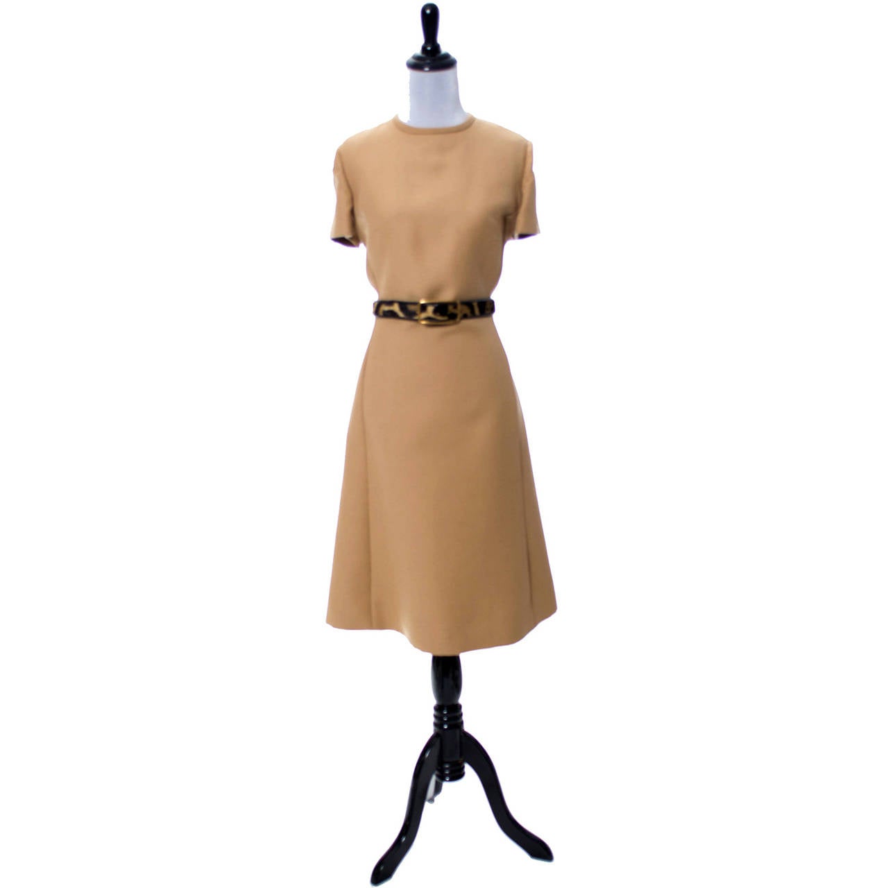 This exceptional vintage dress suit was designed by Gary Keehn and was purchased at Birnbaum's in the 1960's.  The suit includes a simple short sleeved camel colored wool dress with a back zipper and fur trimmed belt, and a short double breasted