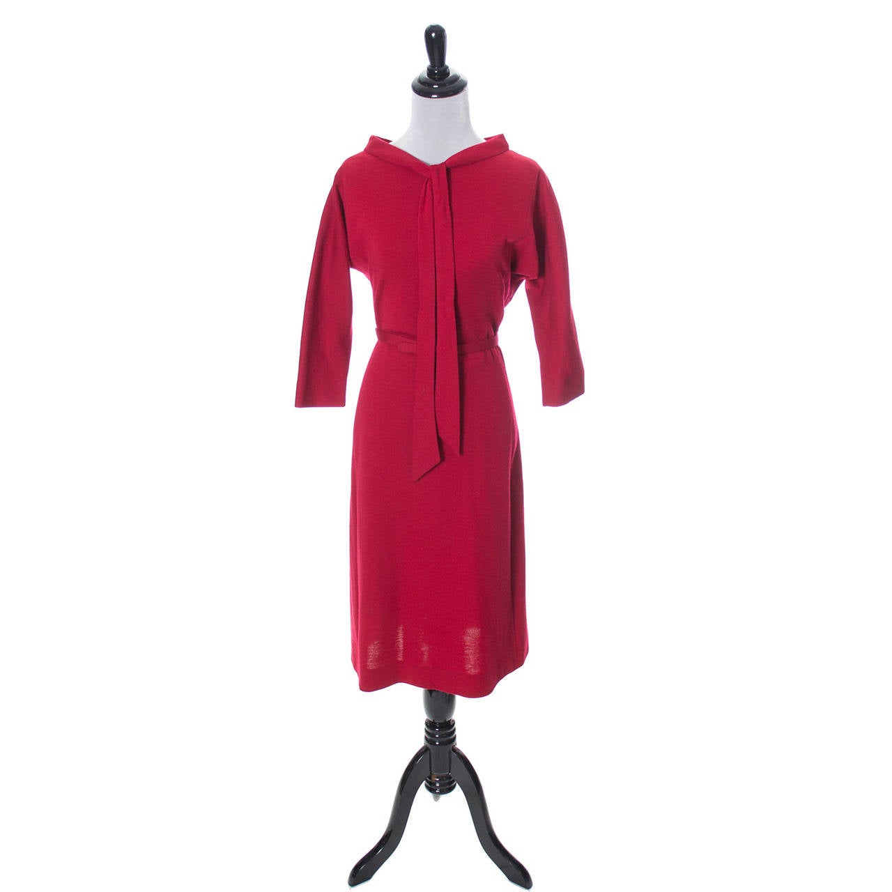 This vintage red wool dress was designed by Norman Norell in the 1960's. The belt is marked Norman Norell and the dress is in excellent condition except for a some wear to the buckle fabric.  There are dolman sleeves, a back zipper, and a wonderful