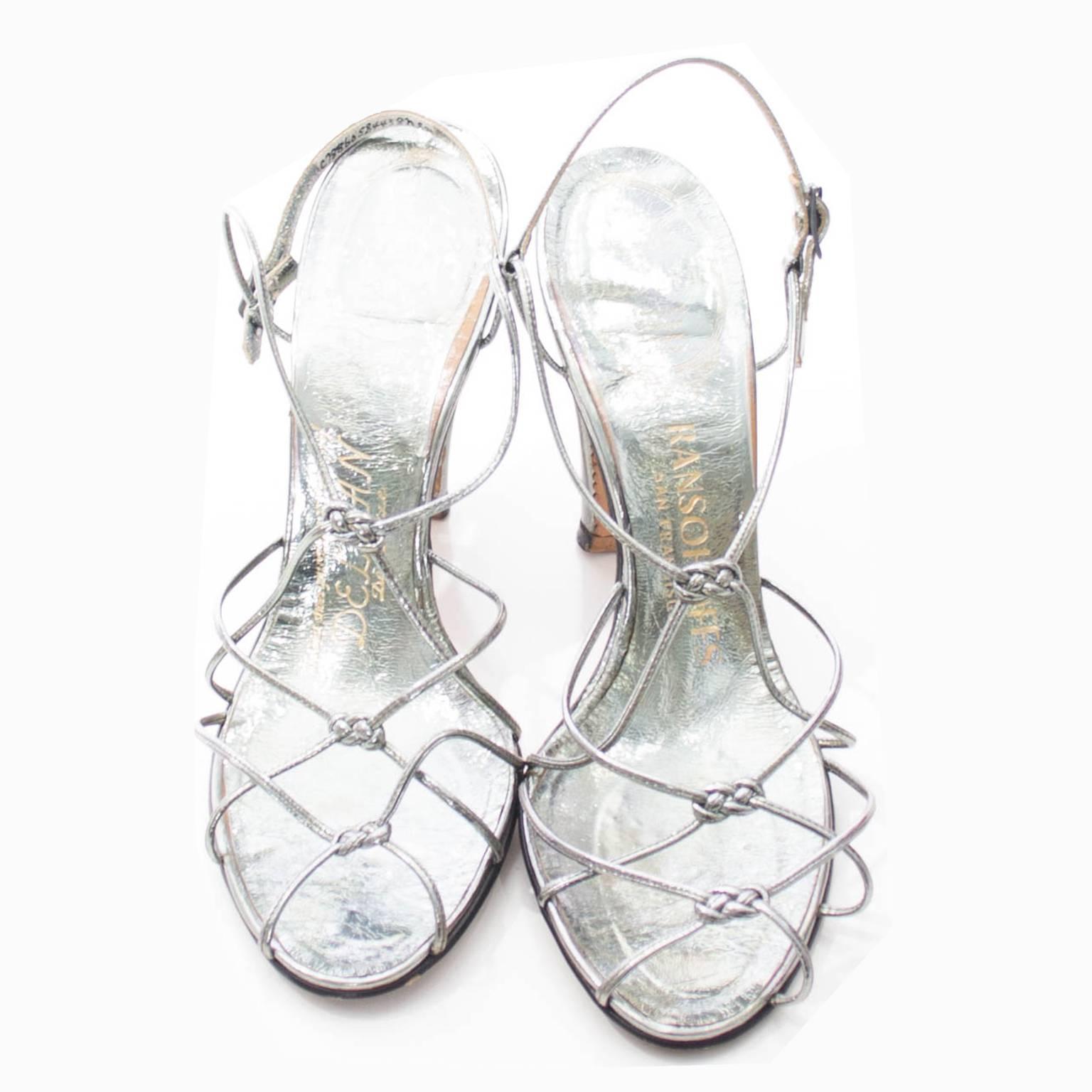 These are spectacular Delman de luxe metallic vintage shoes, purchased at Ransohoff's in San Francisco in the early 1950s. These are strappy silver leather shoes with fabulous knotted details. These measure just barely under 10 inches from the toe