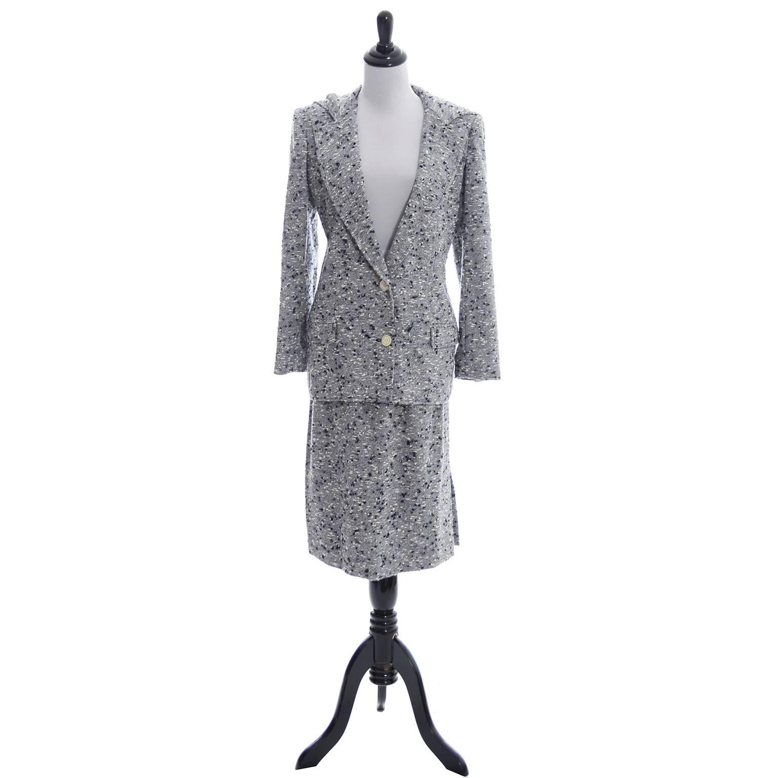 This is a fabulous Valentino vintage skirt suit in a beautiful navy blue and white confetti boucle. Both pieces are fully lined and the fabulous jacket has a hood.  The skirt has side slit pockets and a side zipper. This outfit comes from an estate