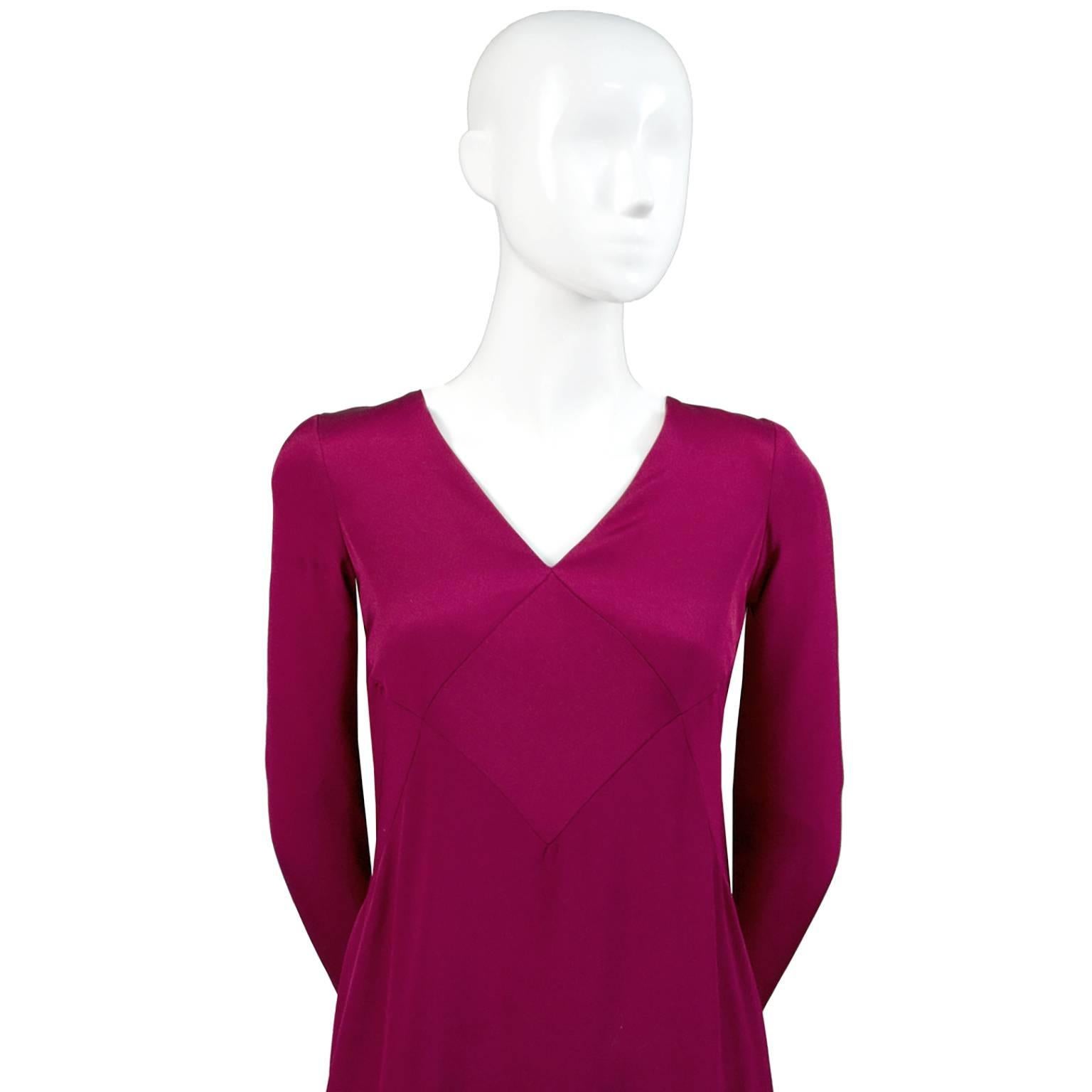 This is a full length silk jersey dress from Oscar de la Renta in a gorgeous shade of a rich berry red.  The dress was purchased at Saks Fifth Avenue in the 1990s.  This dress has an empire waist with nice detail and deep V neckline. There is a back