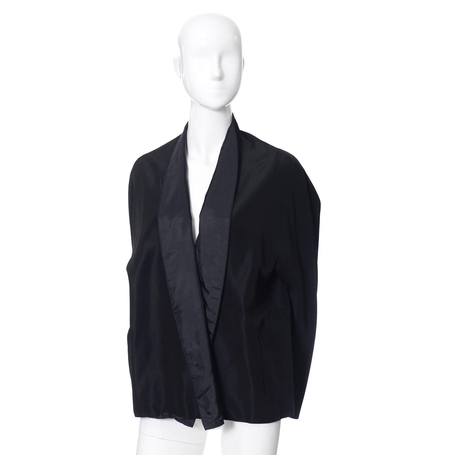 This is a great basic to have in any wardrobe! A Donna Karan Signature black loose fitting jacket with a collar that can be worn like a shawl tuxedo style lapel.  The jacket was made in the USA of imported fabric and it is in excellent condition. 