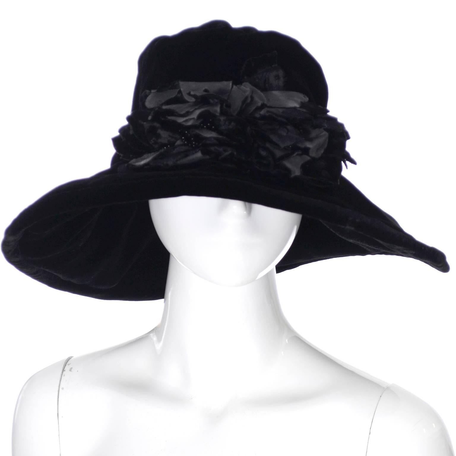 This is a fabulous Donna Karan black velvet floppy hat with a wide brim and beaded silk flowers.  The hat is labeled one size fits all, it has a 23" circumference on the inside at the band.  The brim is 5" wide and the hat still has its