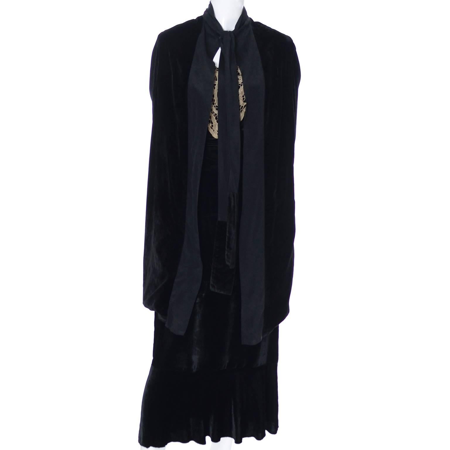 This is a 2 piece outfit that includes a pretty tiered black silk velvet 1920's dress with a lace collar, and a matching black velvet opera coat.  The opera coat is lined and trimmed in a silk crepe and has a sash that can be tied into a bow or a