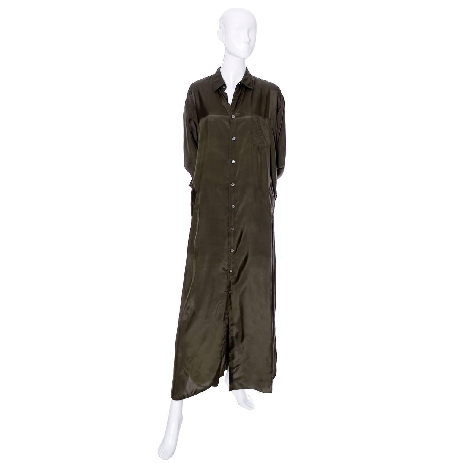 This is a deep olive or army green rayon shirtdress style maxi dress from Comme des Garcons. This vintage piece could be worn as a long coat or a dress, it is in excellent condition and has a lapel pocket as well as front side slit pockets.  You can