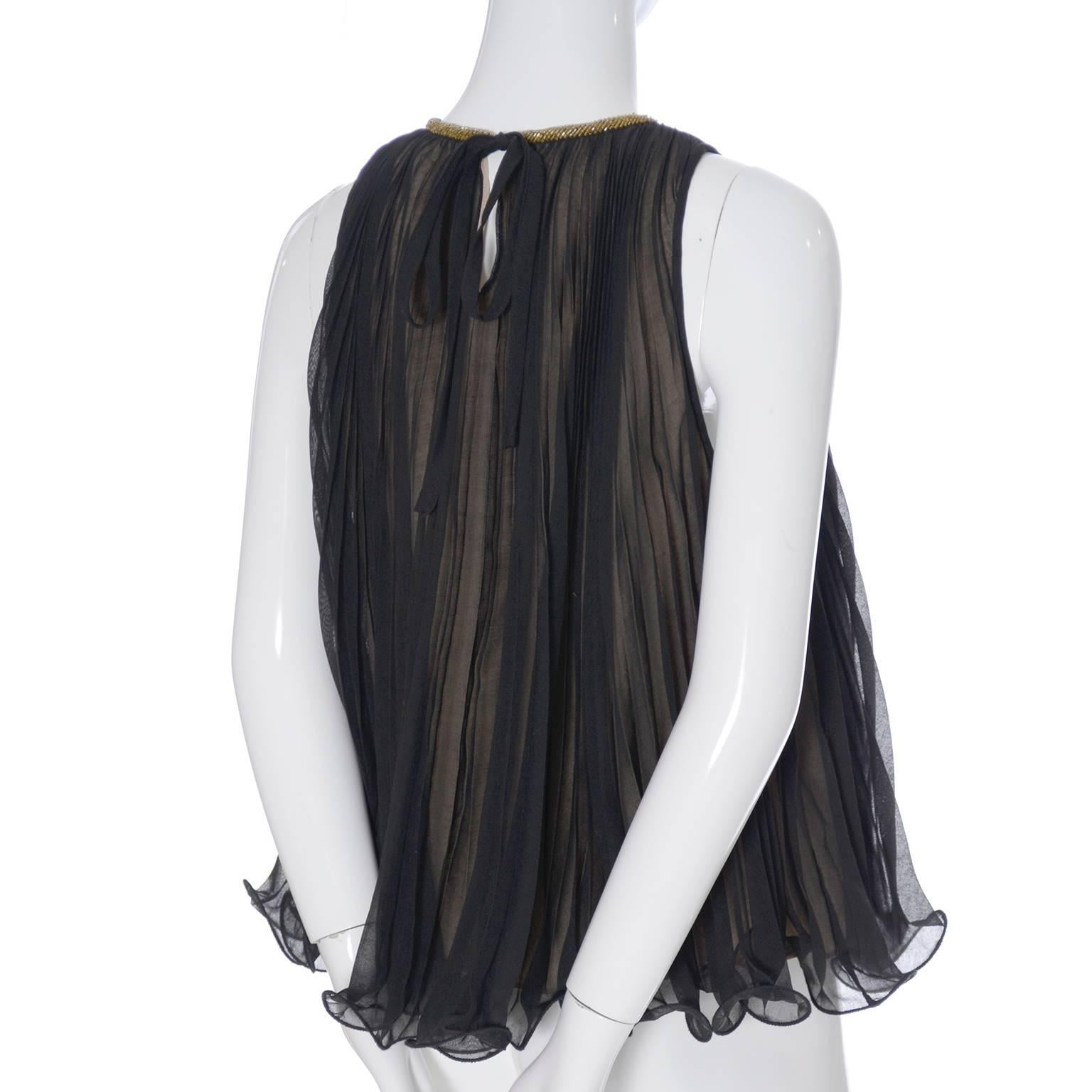 This is a 3.1 Phillip Lim top that is new and still has its Barney's tag attached.  This fabulous pleated sheer black ruffled top is fully lined in a nude flesh toned silk fabric that creates the illusion of gold underneath and it is beaded at the