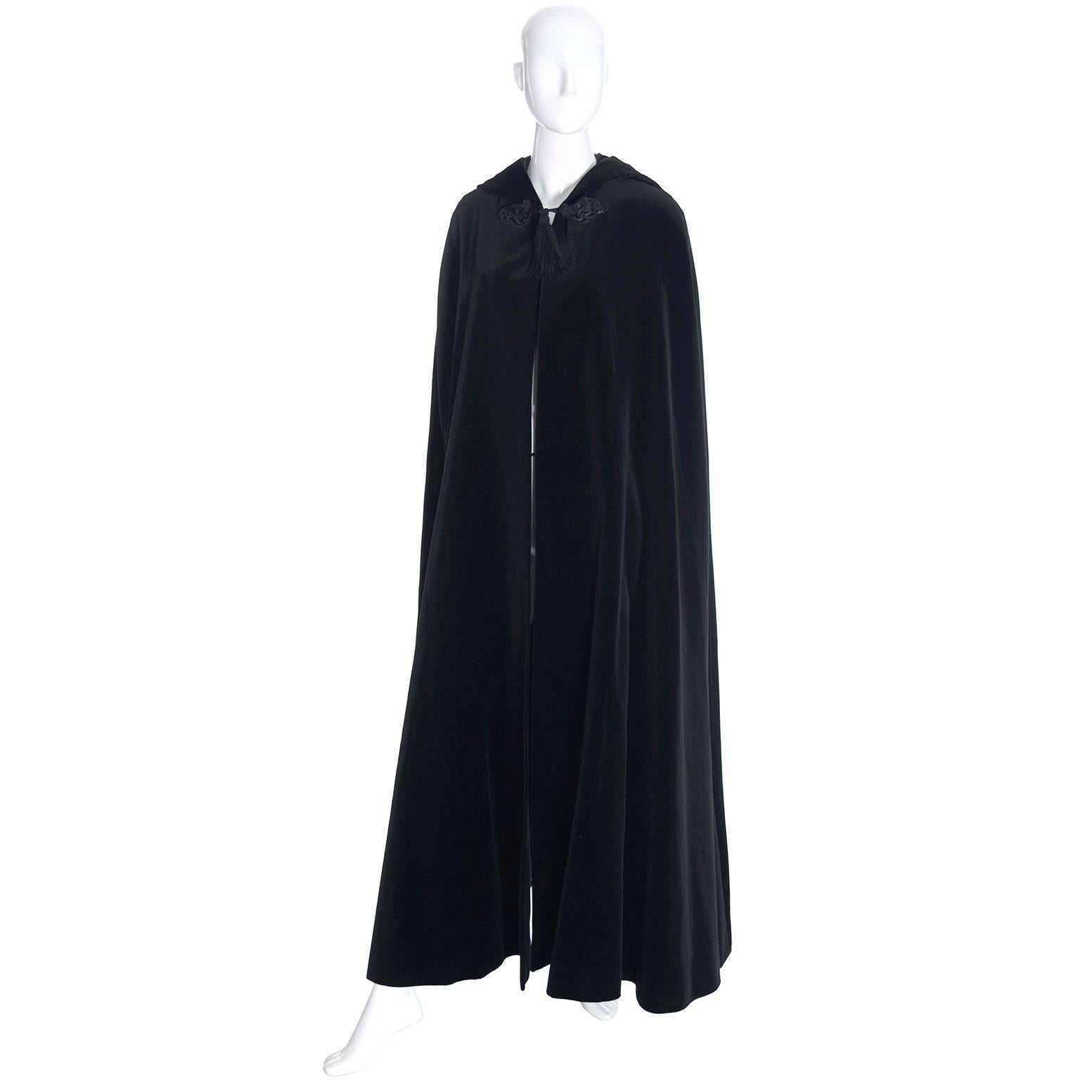 This is a gorgeous YSL vintage black velvet, fully lined opera cape. This dramatic vintage cape has a pointed hood and fine details including silk tassels and soutache trim. This piece has the Yves Saint Laurent Rive Gauche label and is from the