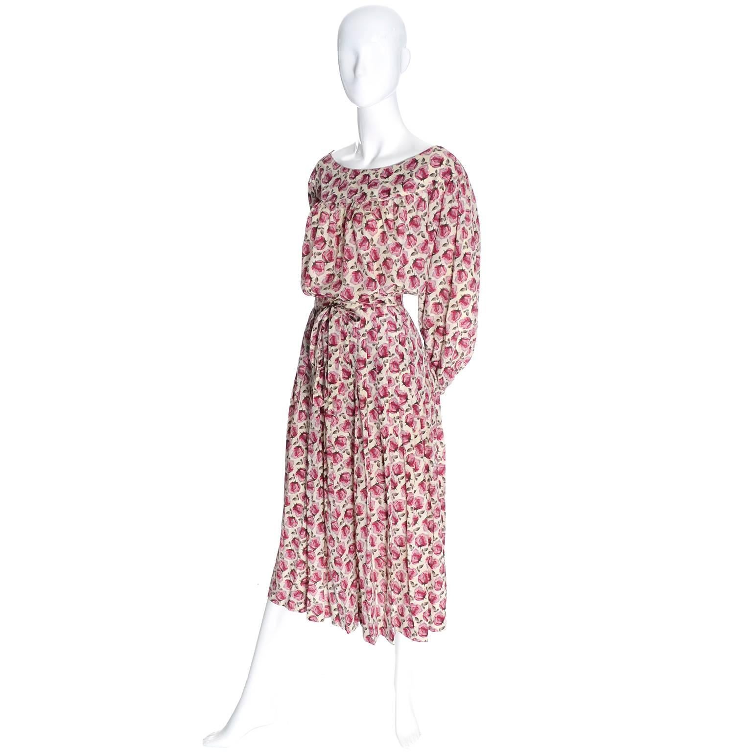 This is a pretty 2 piece dress from Yves Saint Laurent in a beautiful rose print silk fabric.  The blousy peasant top has a ballerina neckline and slips over the head. The skirt is pleated with a side metal zipper and has its original fabric belt. 