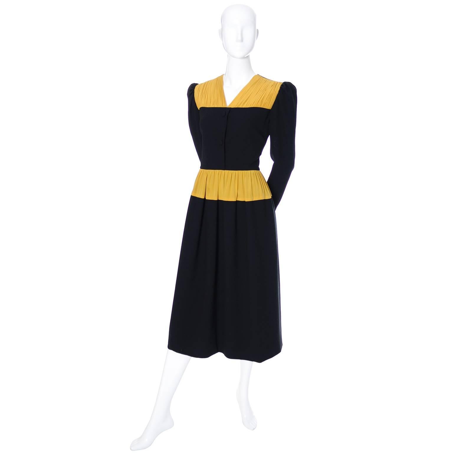 This is a really lovely vintage dress from Carolina Herrera in black wool crepe with gorgeous marigold yellow pleated silk at the neckline and the waist. This dress zips up the back center seam and has decorative buttons on the bodice. There are
