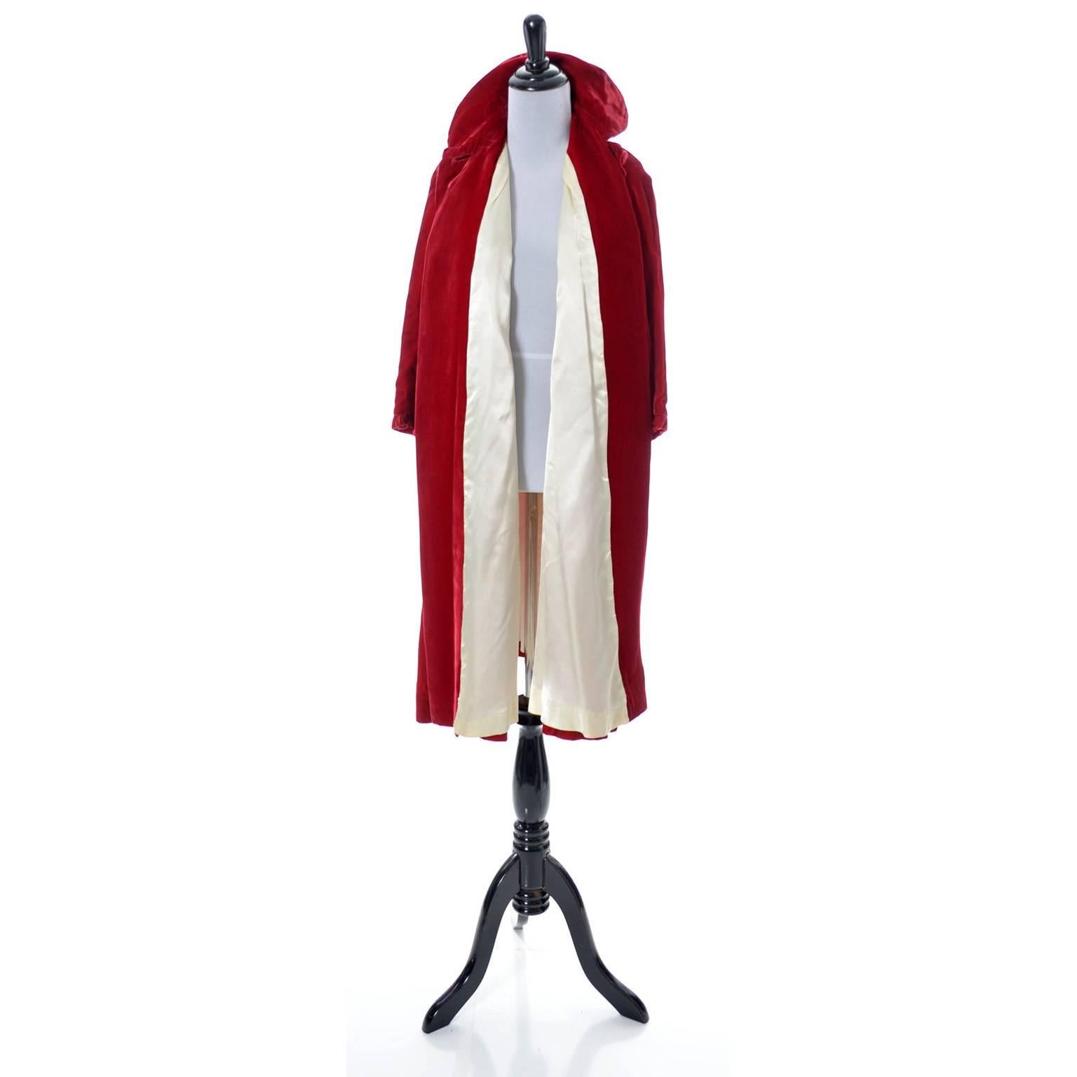 This is a luxe vintage holiday cherry red velvet coat with lovely ivory silk lining. This vintage opera coat was purchased at the Northwest department store Meier and Frank in the 1960's.  There are pretty fabric covered buttons and pockets - the
