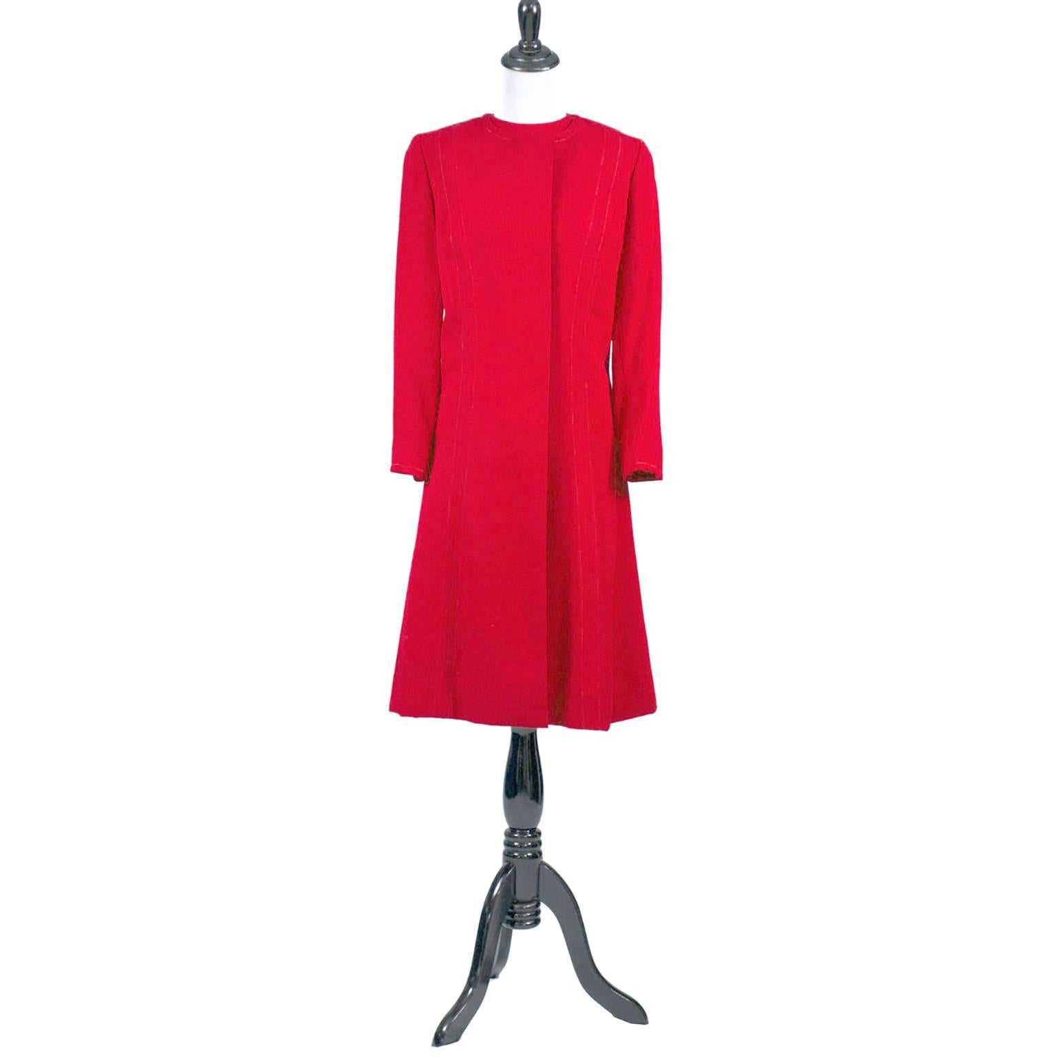 This is the perfect holiday ensemble! A vintage late 1950's ore early 1960's sleeveless red sheath dress with a matching red coat that has gorgeous green silk lining.  This dress suit was acquired when I purchased the entire estate of a prominent