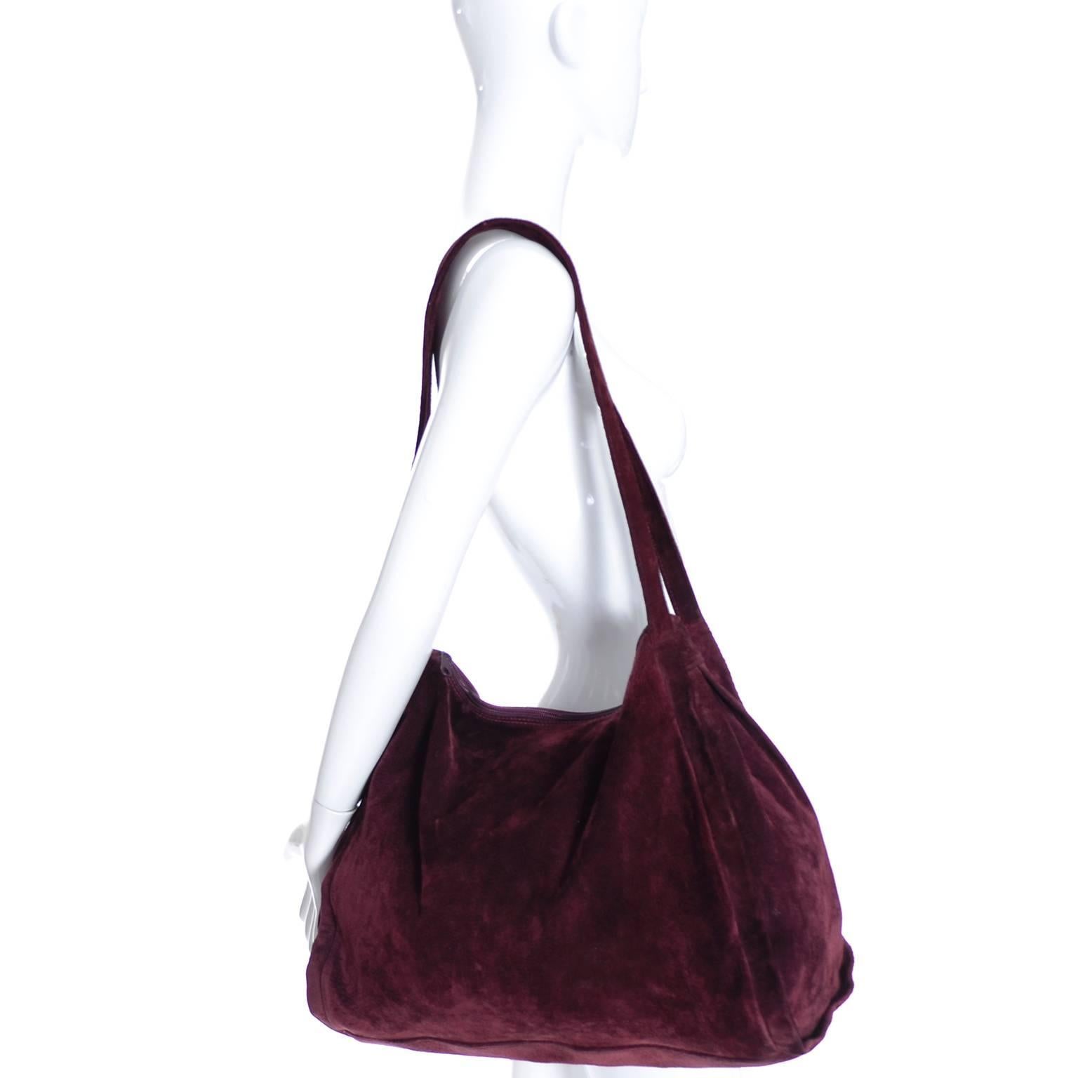 This is a gorgeous suede vintage bag from Donna Karan.  The bag is in a perfect shade of burgundy with a top zipper.  This bag measures 17