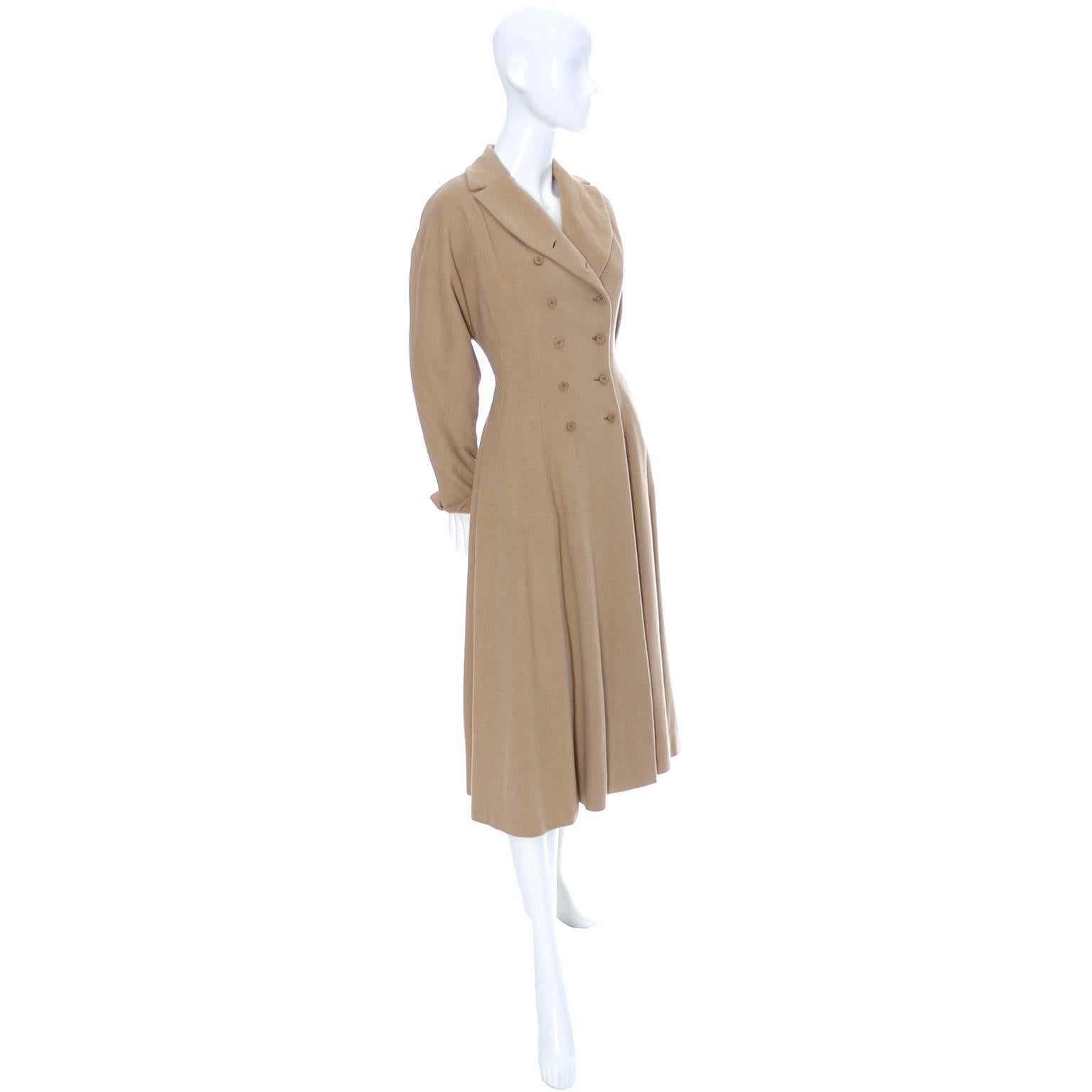 This is an exquisite, rare vintage 1940's coat from designer Vera Maxwell.  It is in excellent condition and comes from a prominent Northwest estate of high end designer mid century clothing. The coat has a full skirt, fitted waist, dolman sleeves