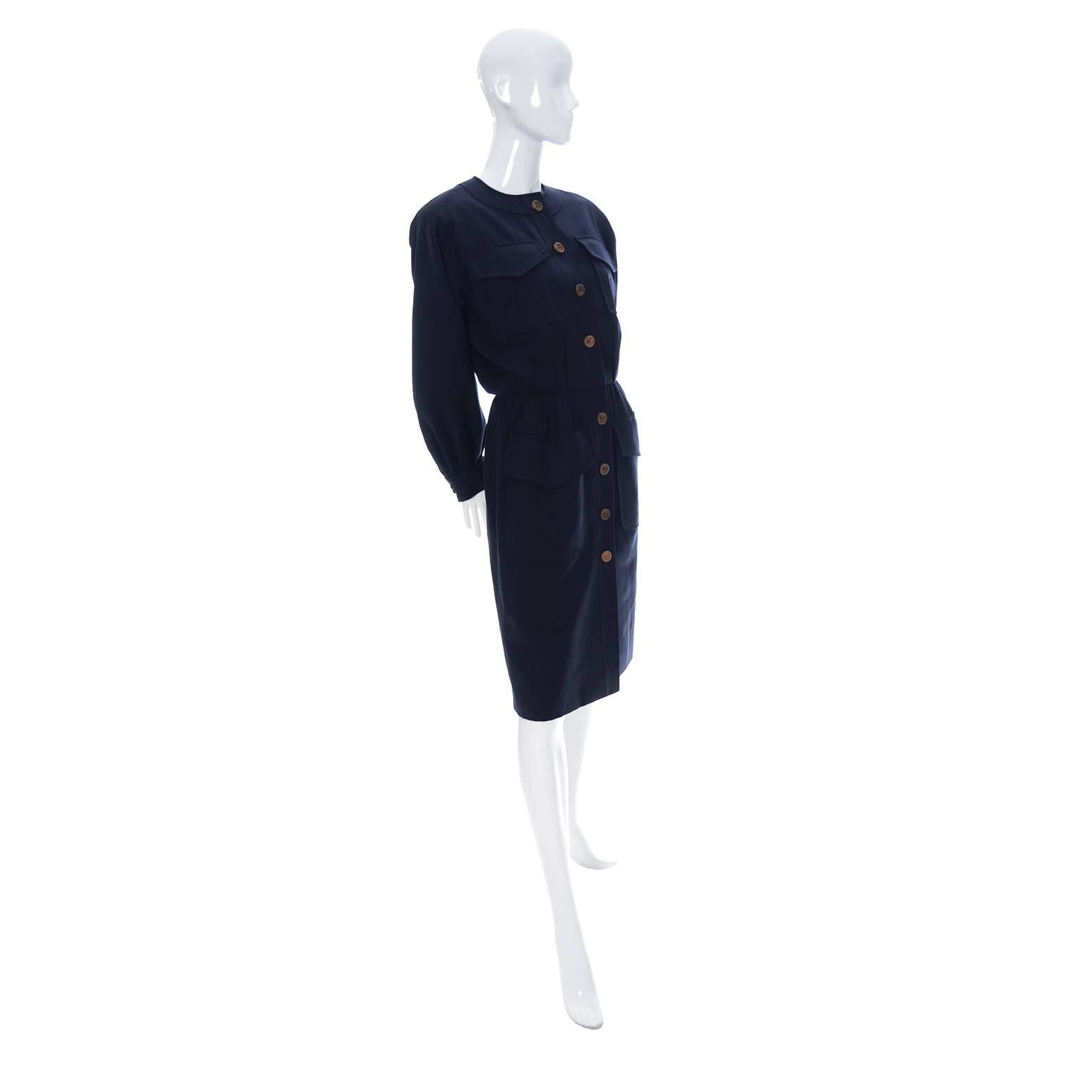 This is a classic vintage dress from YSL in navy blue wool with wood buttons and 4 front pockets. We are always stunned at the quality of Yves Saint Laurent vintage pieces and this dress is made so beautifully! This dress is in excellent condition,