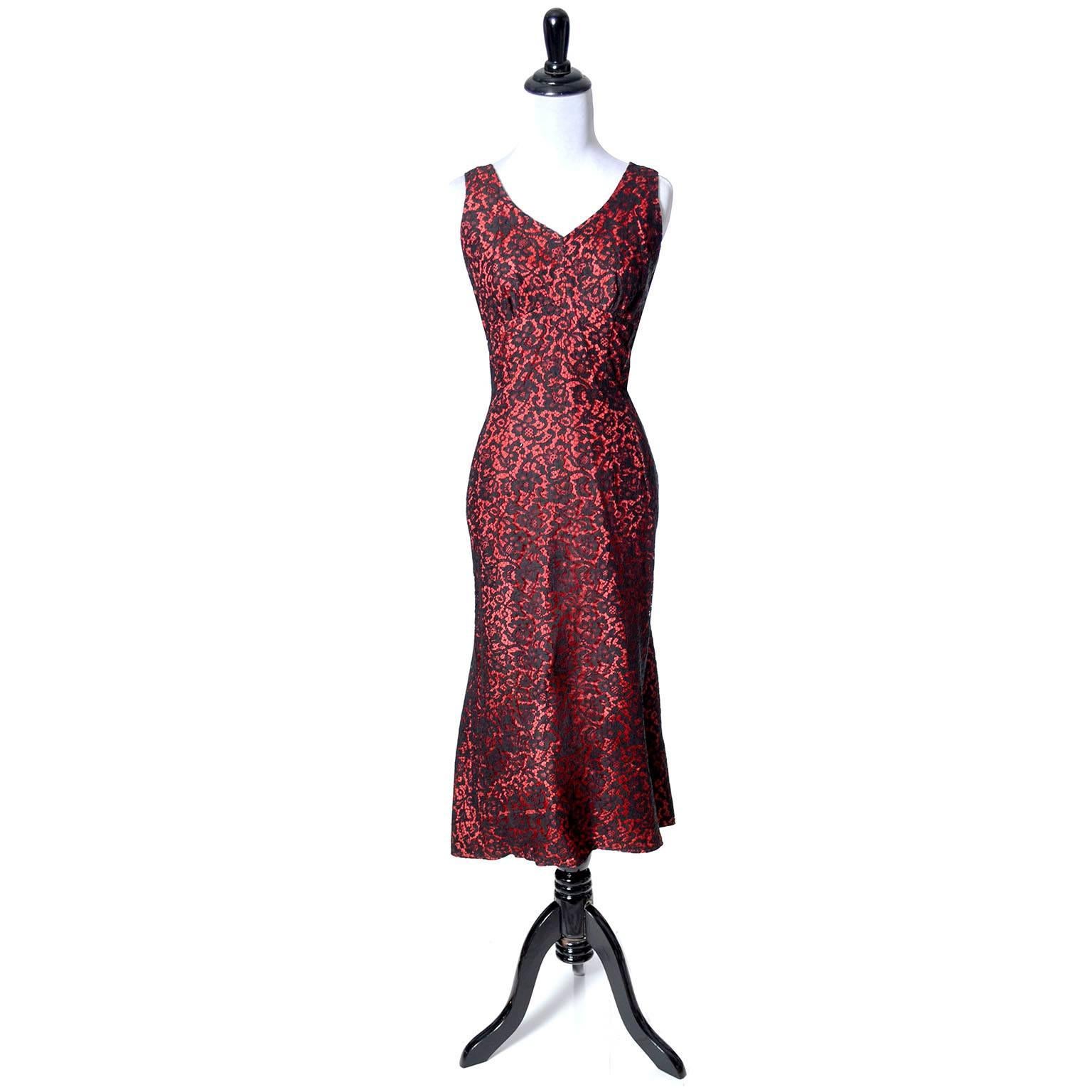 This is a fab vintage 1950s designer dress from Emma Domb. This beautiful early 50s dress is sleeveless, with a fun skirt that looks almost like a fish tail hem in the back. The dress is red taffeta with black lace overlay and opens with a 13” side