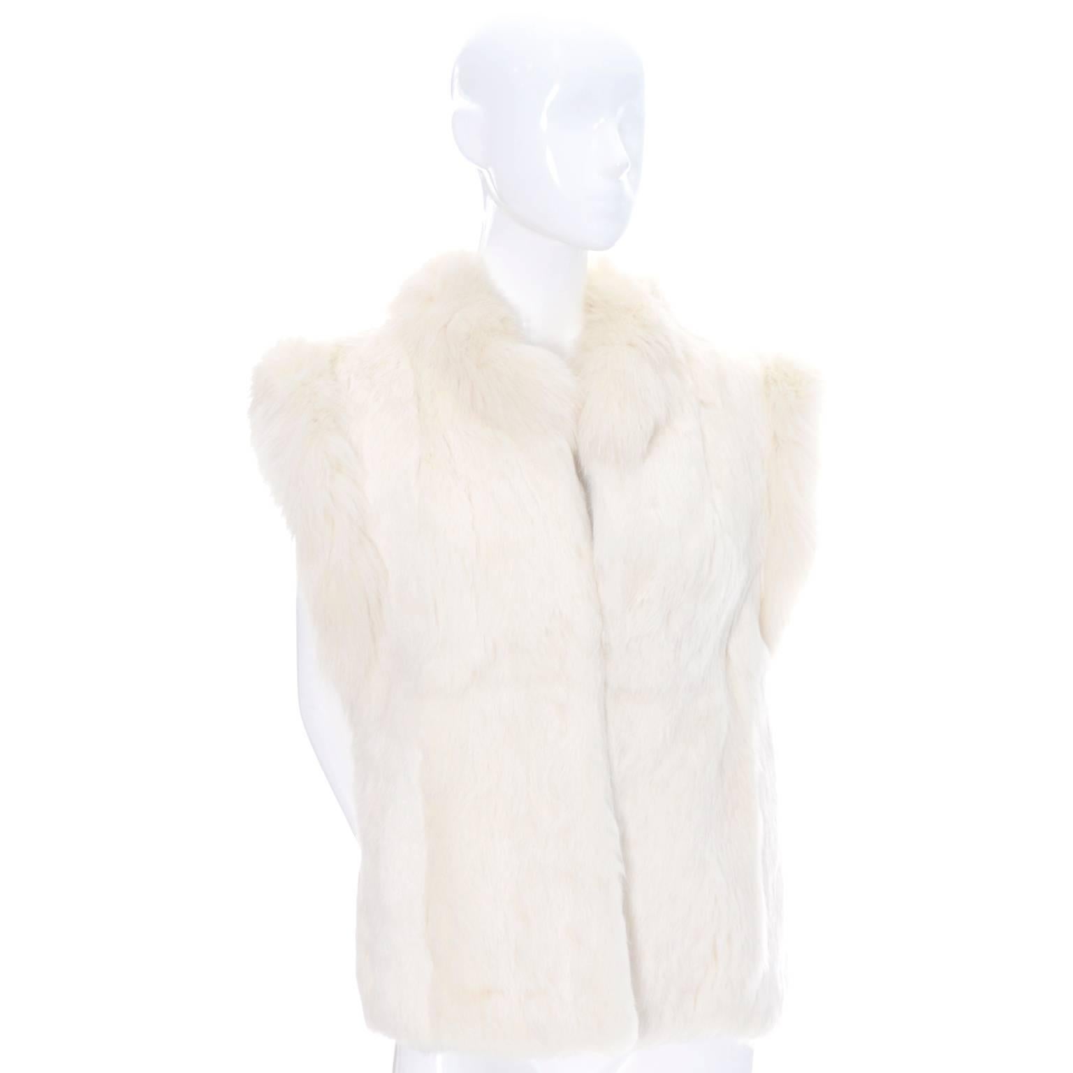 This is a 1980's vintage ivory white rabbit fur vest with open front that fits up to a size 40