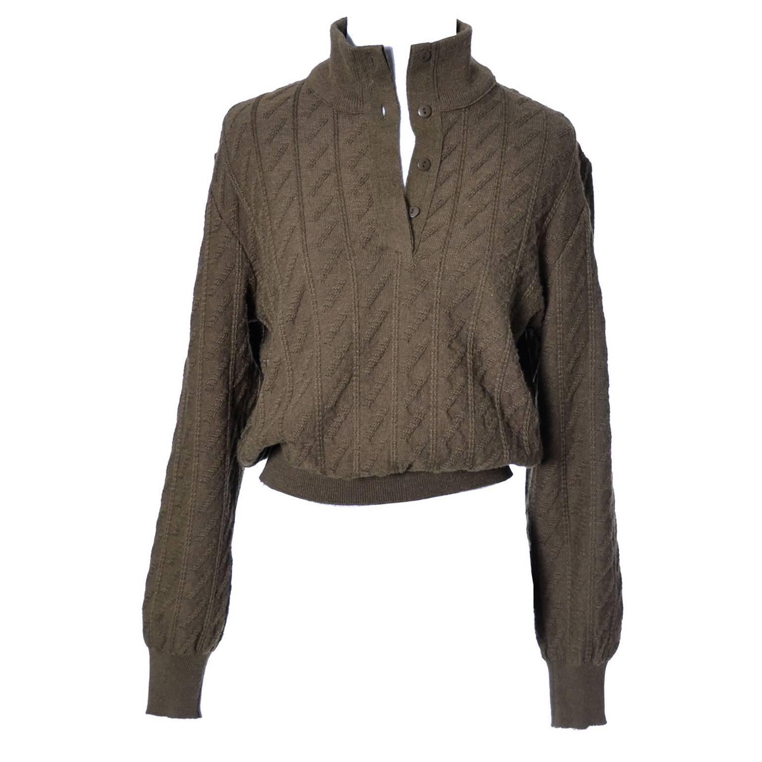 This is a late 1970's or early 1980's Courreges vintage brown cable knit sweater in a camel hair, wool, acrylic knit blend. A really nice, pretty soft brown Fall sweater with buttons at the neckline in excellent condition. When laid flat, this