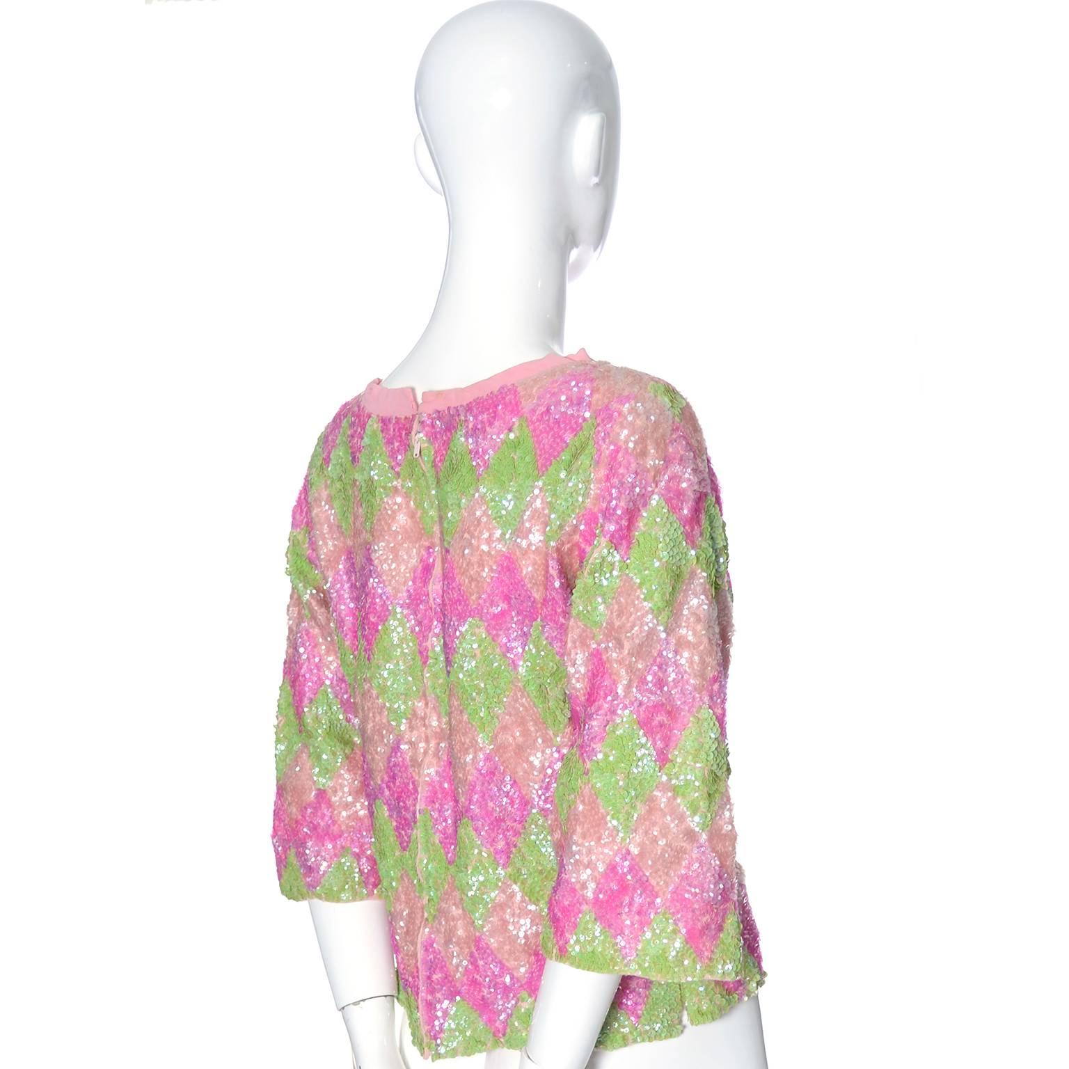 This is a lovely 1960s vintage Valentina Pastel sequin wool sweater top with 3/4 length sleeves and a back metal zipper.  The top is fully lined in pink silk and shows minor wear, mainly being some yellowing on the inside of the lining in the neck