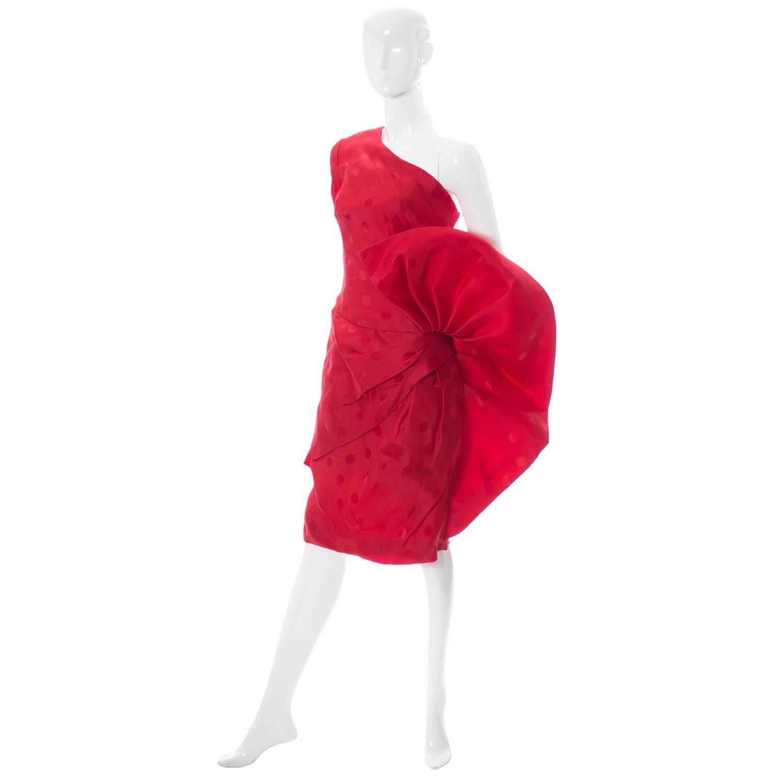 This is a 1980's show stopper vintage dress designed by Fernando Peña.  This is an amazing dress with a giant flared piece of fabric on the side that looks like a beautiful open flower!  The dress appears unworn and is in a gorgeous red satin