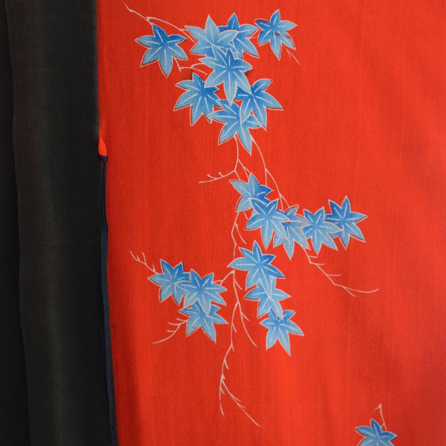 This is a fine vintage silk kimono from a collector's estate. This woman had an incredible collection of Asian textiles including many kimonos.  This one is in red, black and brown silk with moans, temples, houses, and pretty blue and white flowers.