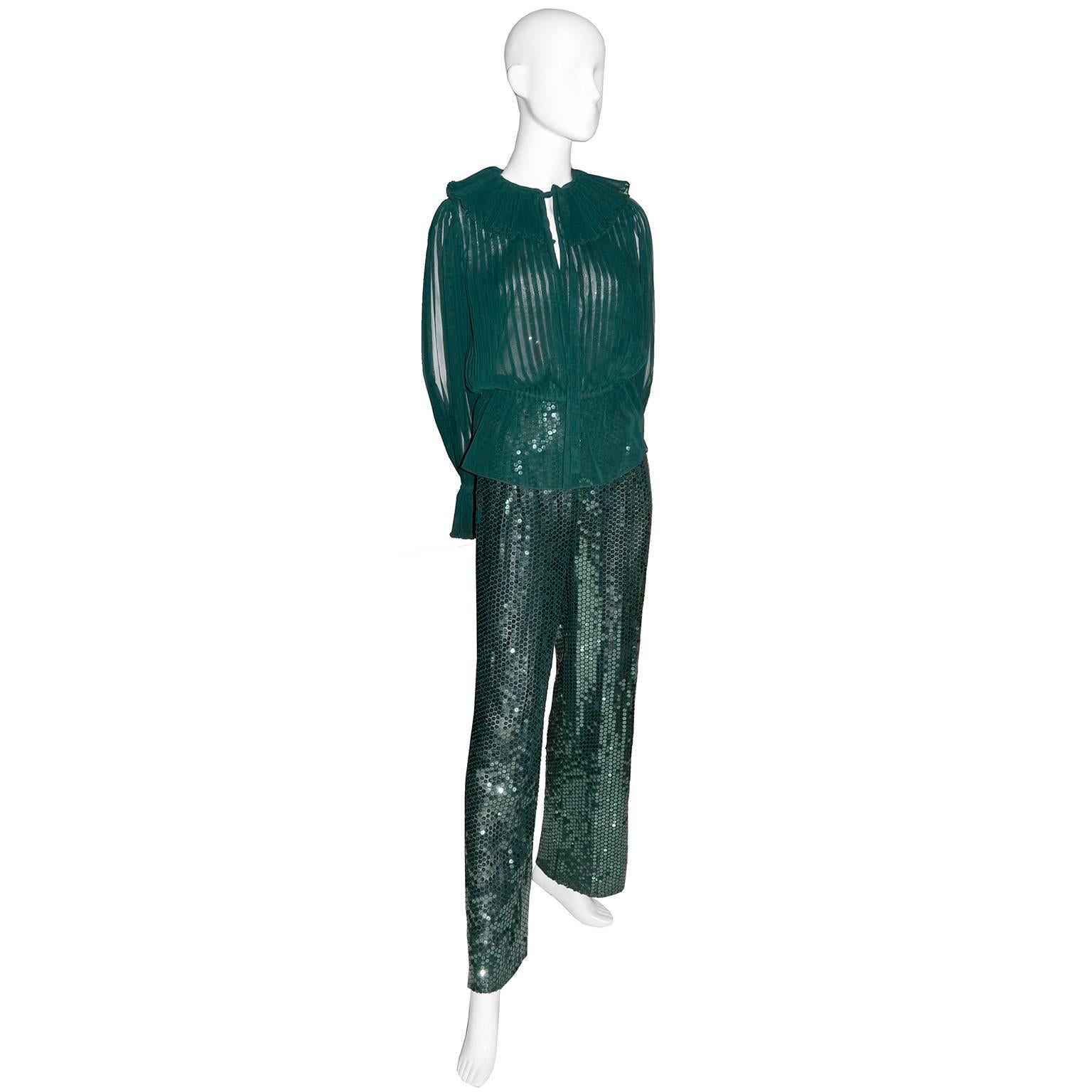 This pretty vintage Oscar de la Renta 2 piece outfit includes a pair of high waisted sequin pants and a beautiful pleated blouse with keyhole bodice opening that ties and poet sleeves with pleated ruffles.  This outfit can be worn with the peplum of