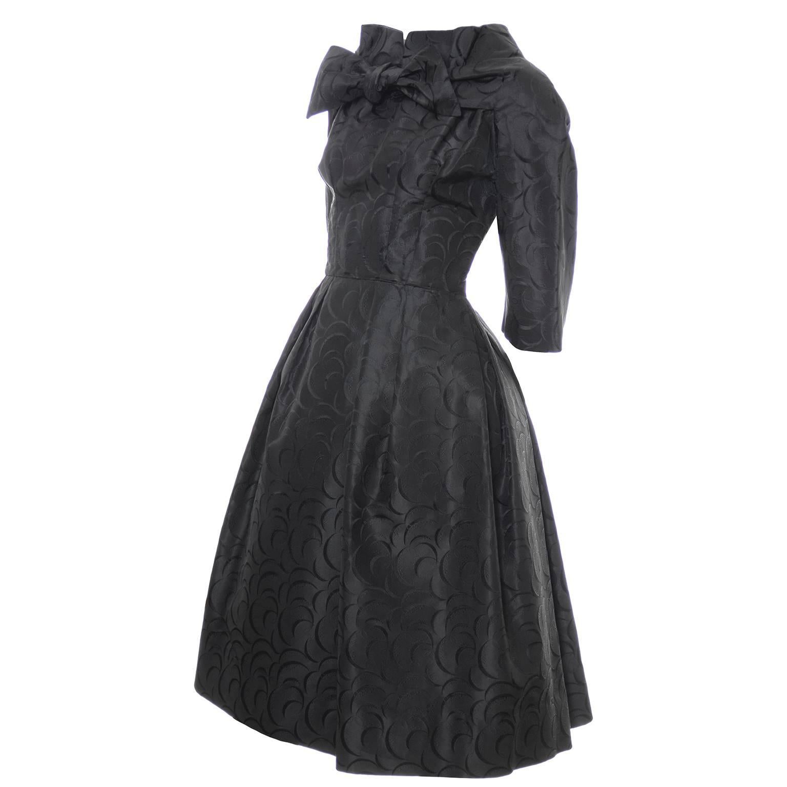 This is a fabulous vintage dress designed by Daniel Werle of Beverly Hills in the 1950's. This rare, collectible dress has a stand up collar, 3/4 length sleeves, back zipper, and pretty bow and the neckline.  The fabric is gorgeous black taffeta