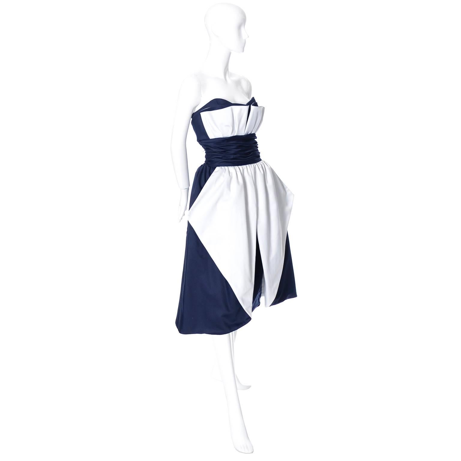 This pretty vintage dress was designed by Victor Costa for Neiman Marcus in the 1980's.  This strapless dress is deep blue with pretty white fabric dramatic details. There is a slim under skirt under the fuller 