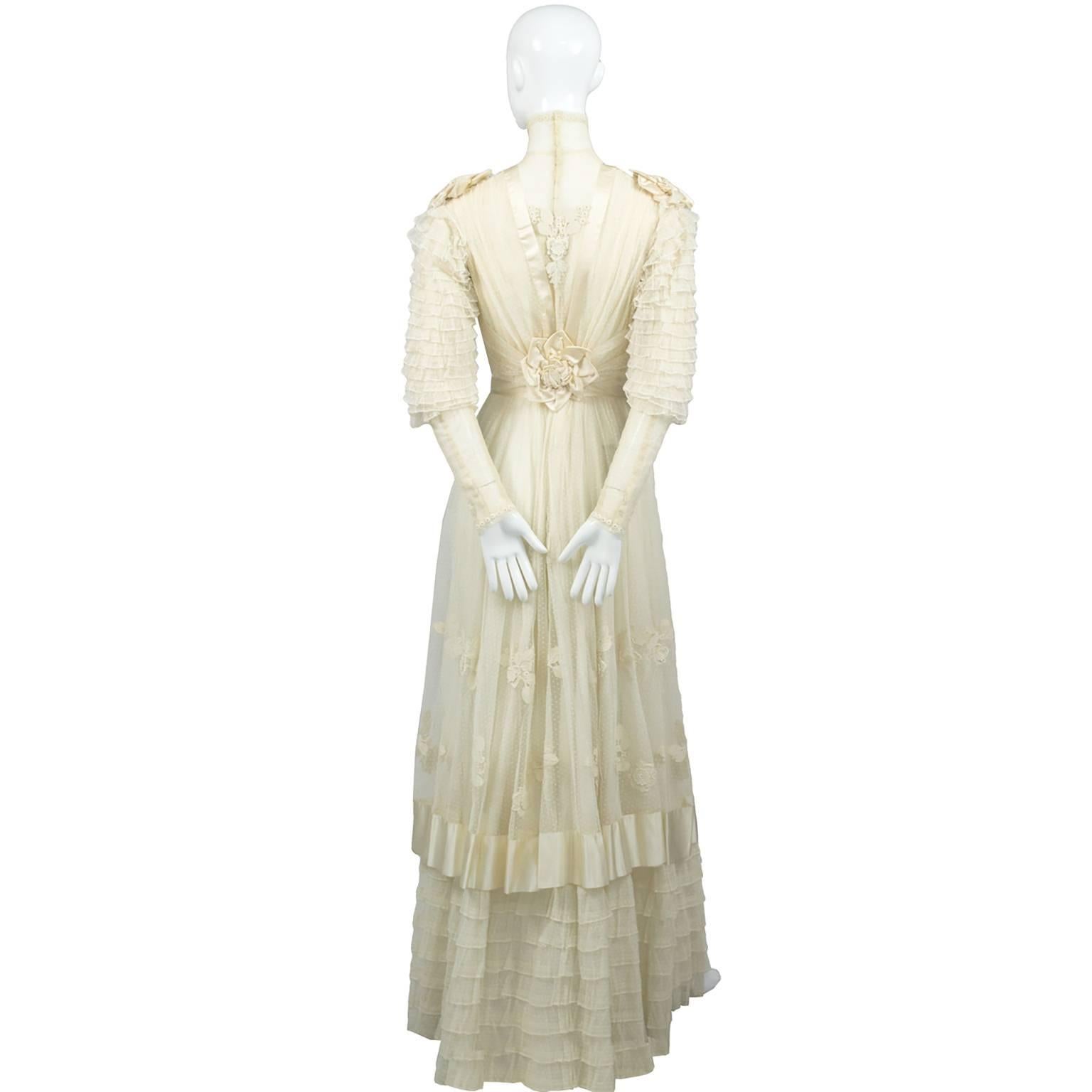 This is an exceptional Antique lace and netting Edwardian vintage wedding dress with short matching veil. The dress is made of creamy dotted fine netting with lace appliques, silk roses and silk trim. The high neck is made of the fine netting, the