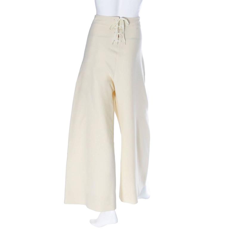 These are Jean Paul Gaultier vintage sailor pants with the Gaultier2 label. The pants are classic sailor style with laces in the front and in the back and they have plastic anchor buttons.  These high waisted pants are wide legged and made of a