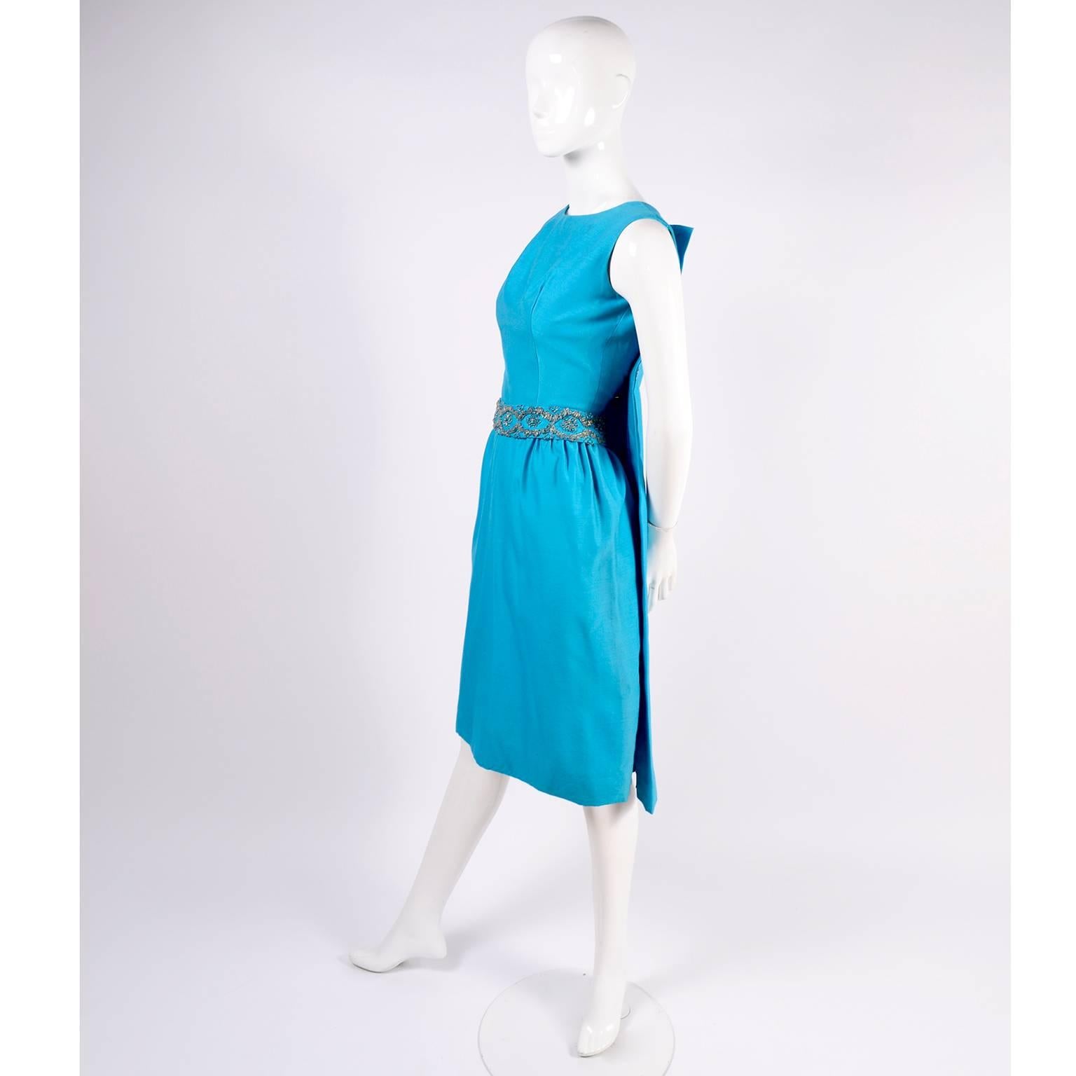 This is simply an incredible Suzy Perette late 1950's vintage dress in blue silk with a beaded belt, beaded buttons, and a removable back panel or cape that can be taken off to reveal a beautiful open back!  This dress is in excellent condition,