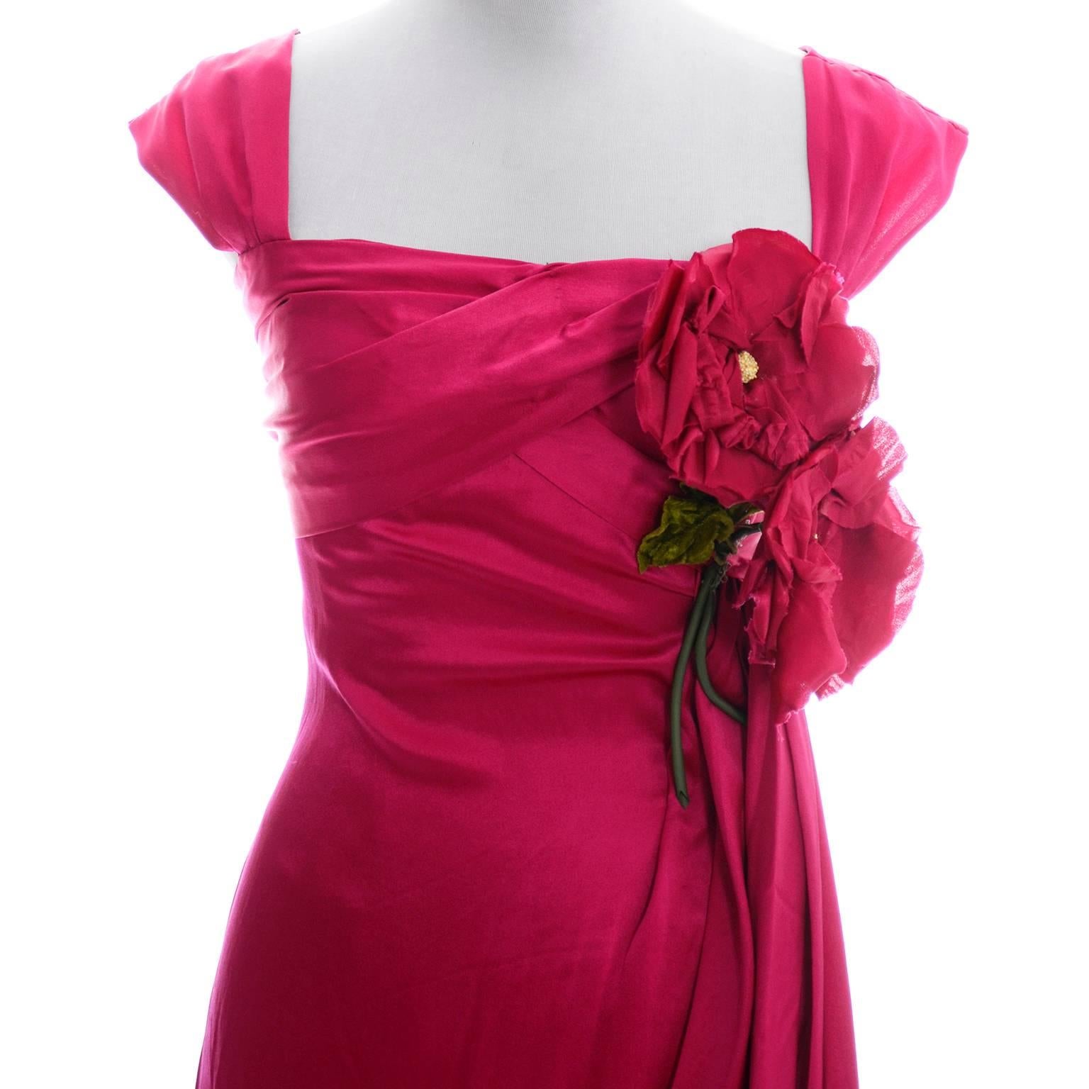 This gorgeous dress is simply divine in a raspberry red silk fabric with pretty roses on the bodice. The dress has lovely draping and ruching, and closes with a back zipper.  This dress has no labels but was custom made by a fine seamstress or