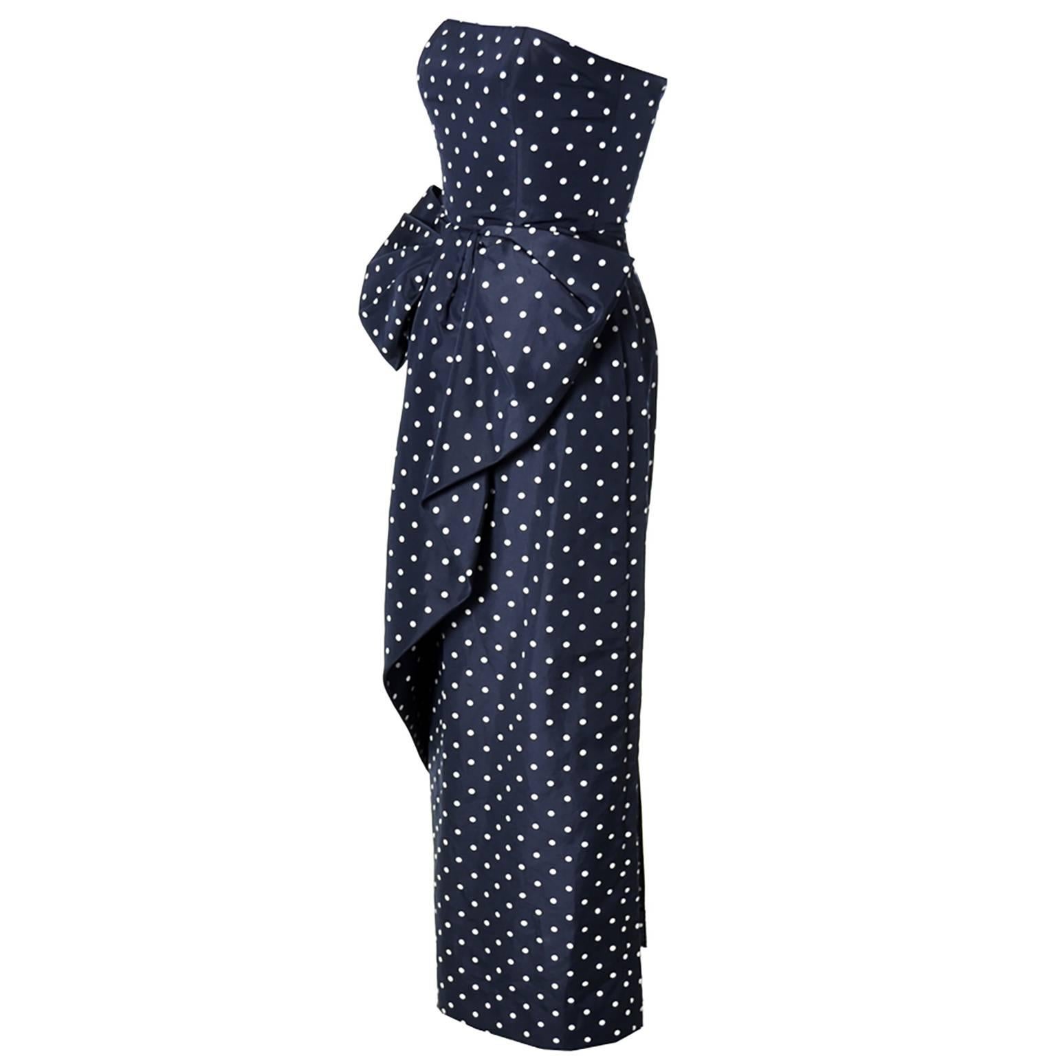 This strapless navy blue vintage dress with white polka dots is from Victor Costa.  This is a great 80's vintage dress with gorgeous front bow and a back slit.  This dress is in excellent condition and closes in the back with a zipper and hook and