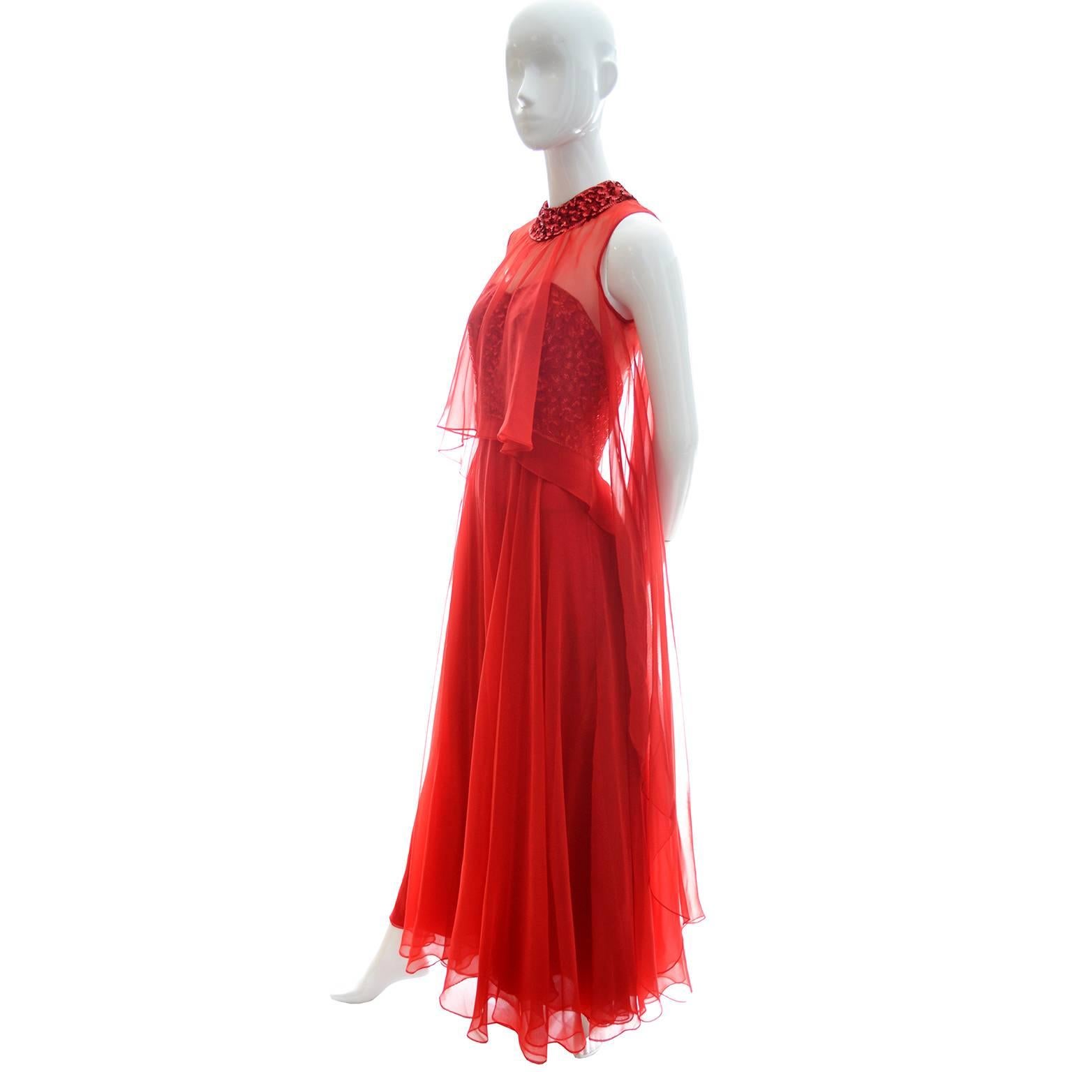 This dramatic vintage sleeveless 70's full length dress has a red sequin covered bodice and a full, flowing chiffon skirt. The bodice has an overlay of sheer red chiffon and a sequin covered collar. This ethereal dress has a back zipper and I would