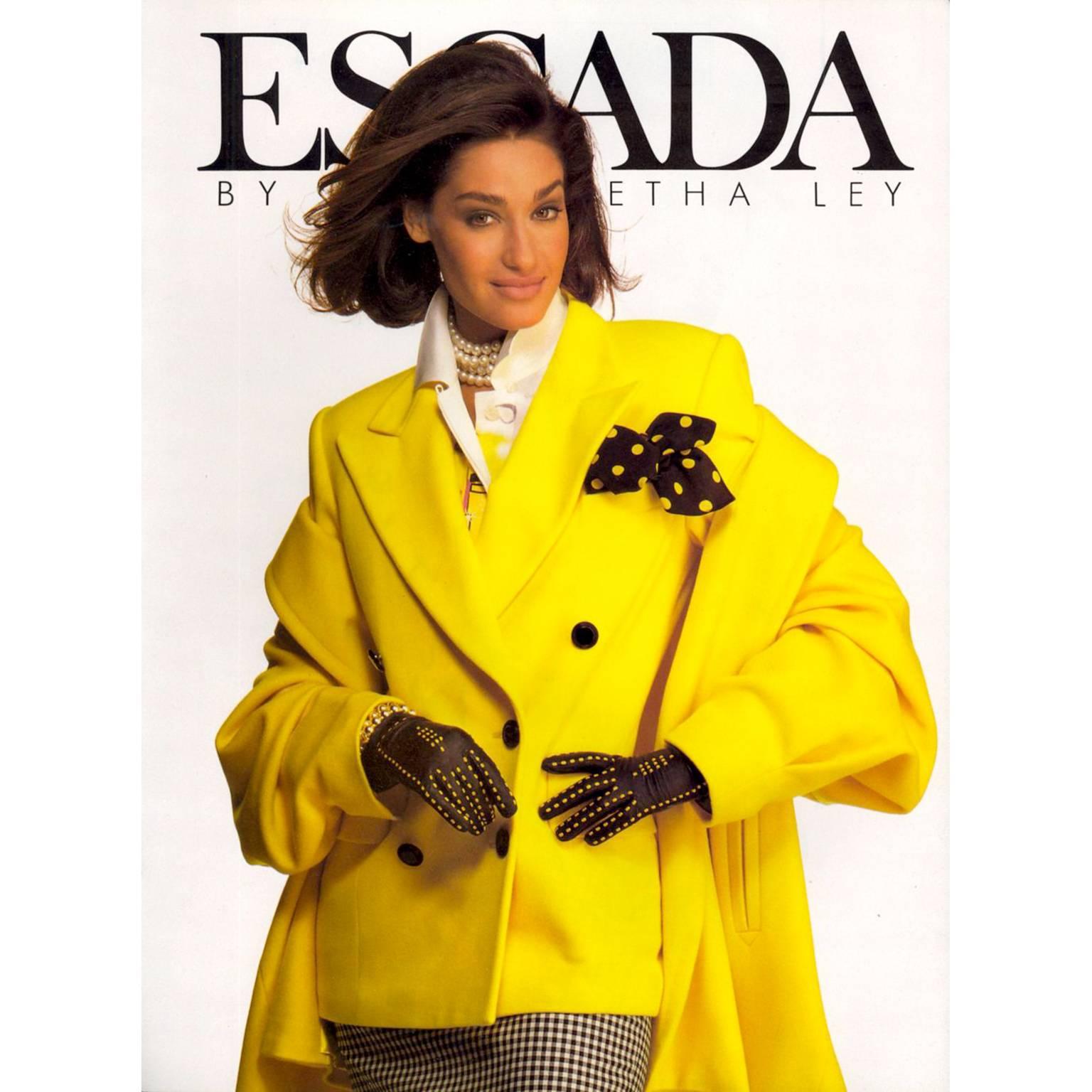 This is an incredible cashmere and wool vintage yellow Escada blazer! This jacket was designed by Margaretha Ley in the 1980's. The color is a gorgeous yellow, it is fully lined with silk logo lining and double breasted with contrasting black